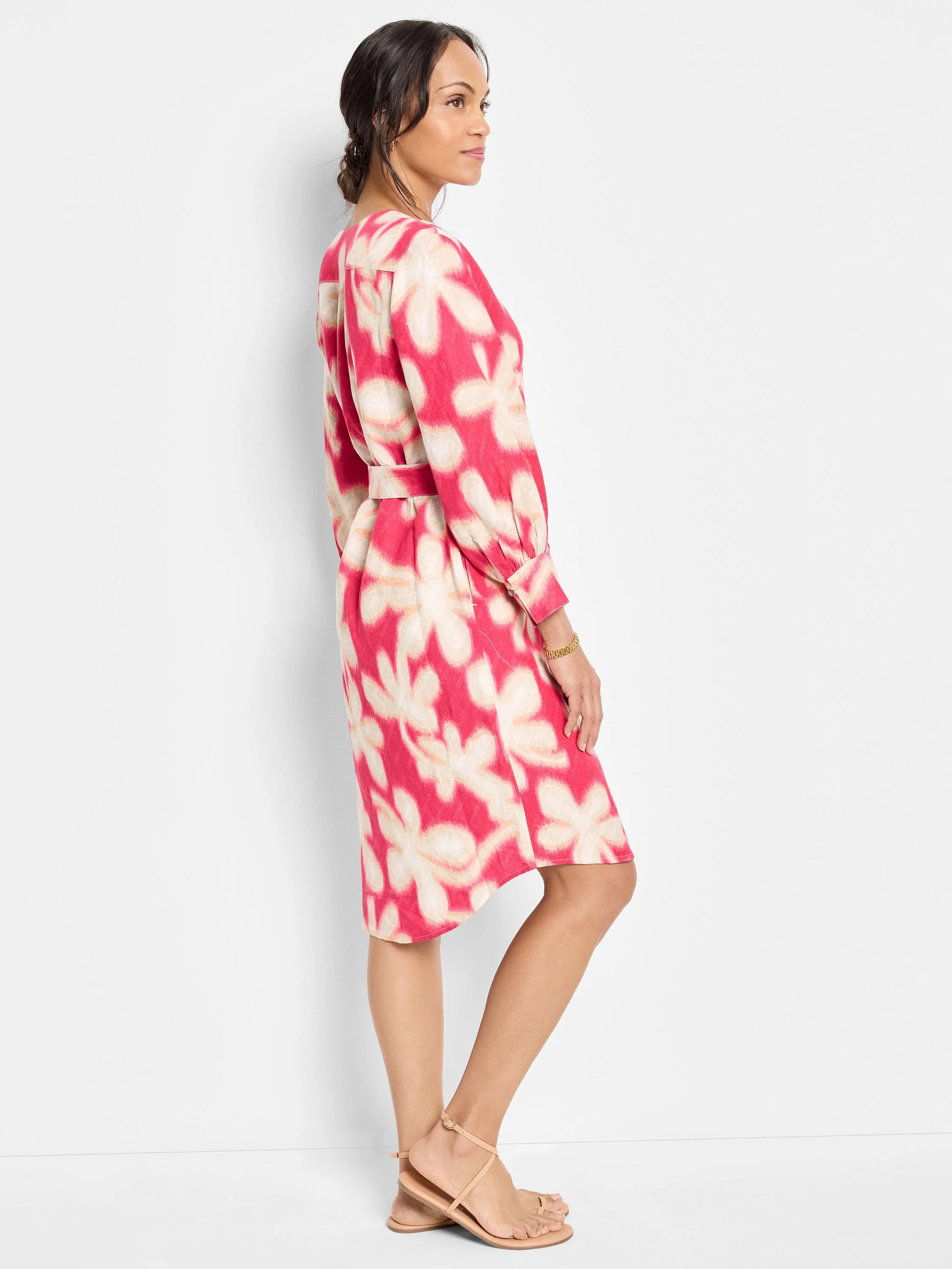 Pink midi dress with beige floral print, belted waist, and long sleeves.