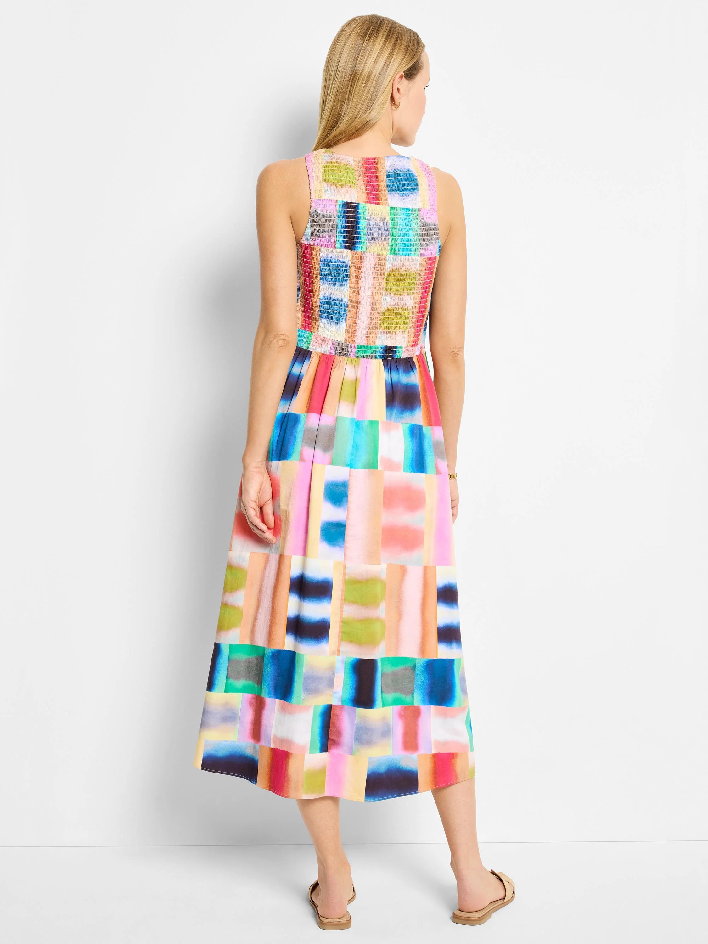 Midi sleeveless dress, multicolored abstract block print in blues, pinks, oranges, and greens. Back view.
