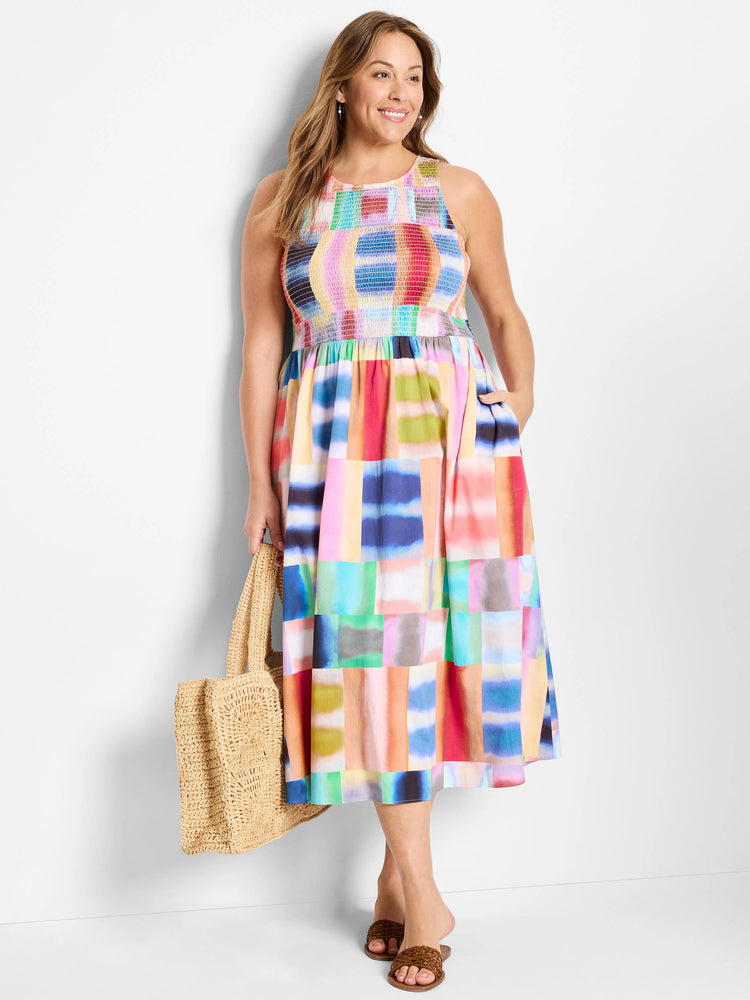 Sleeveless midi dress, multicolored abstract block print (pinks, blues, greens). High neck, smocked bodice.