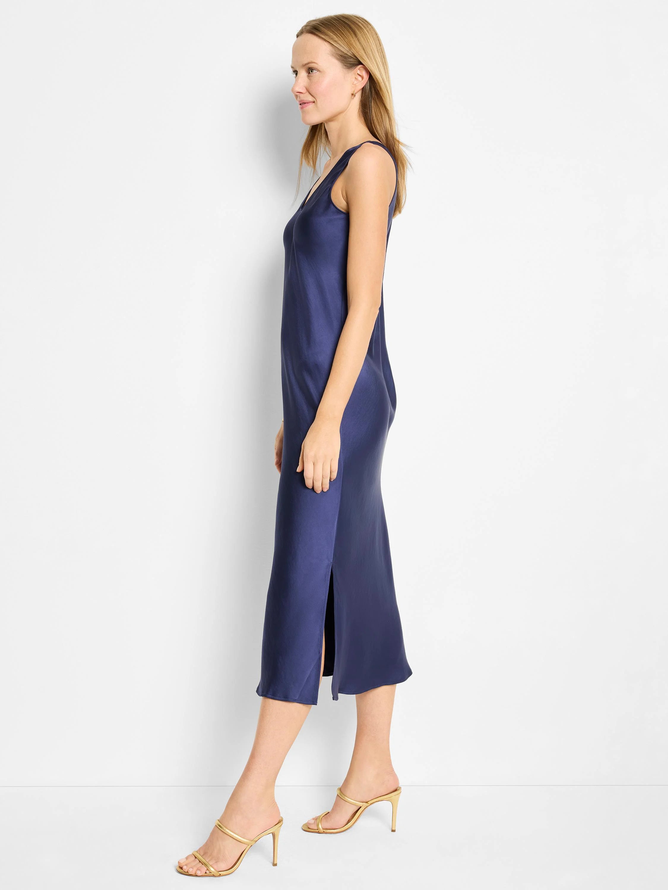 Navy blue bias-cut midi tank dress with a side slit. Shown on a model.