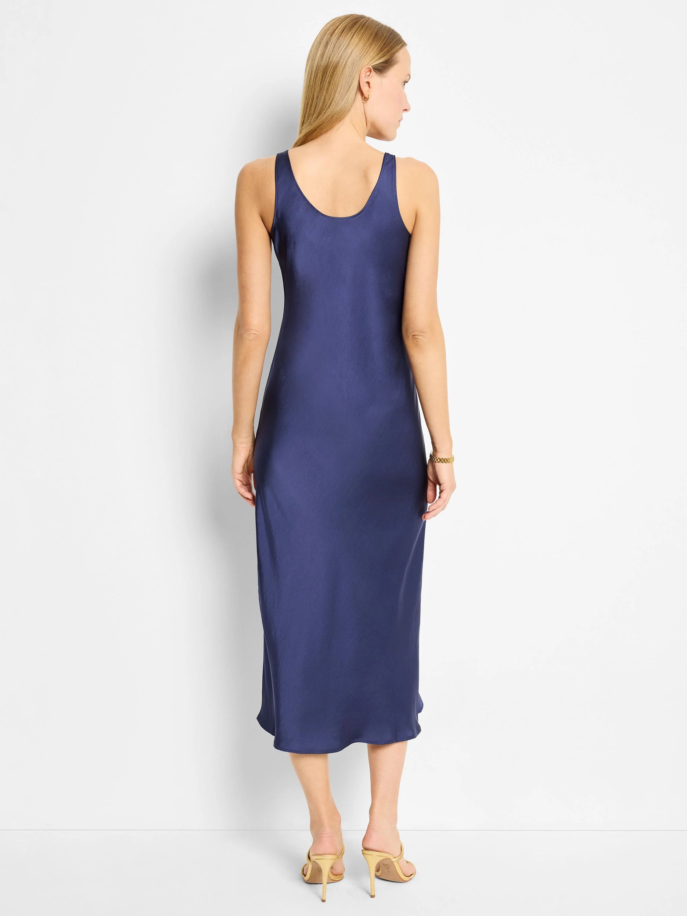 Navy blue bias-cut midi slip dress, sleeveless, scoop neck.