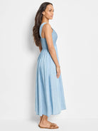 Light blue denim midi dress, smocked bodice, sleeveless, side pockets.