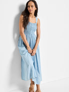 Light blue denim midi dress; smocked bodice, square neckline, thin straps.