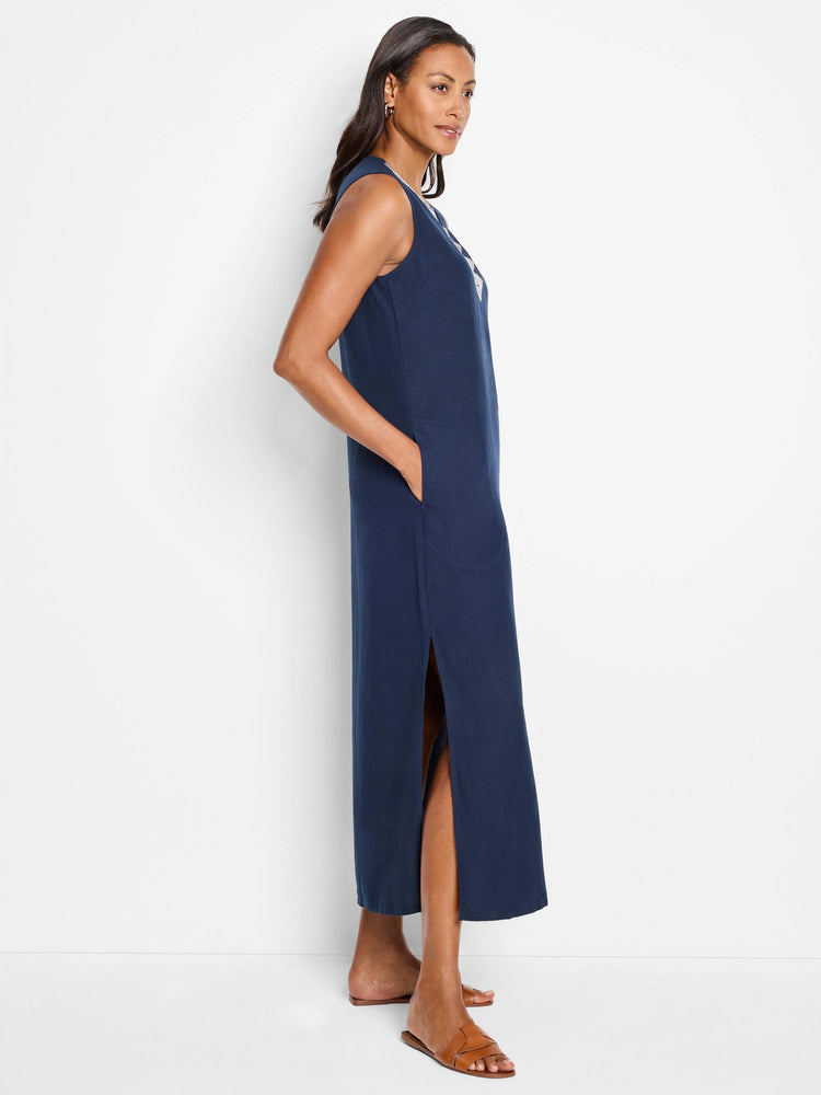 Navy blue sleeveless maxi dress with side slits. Subtle detail near neckline.