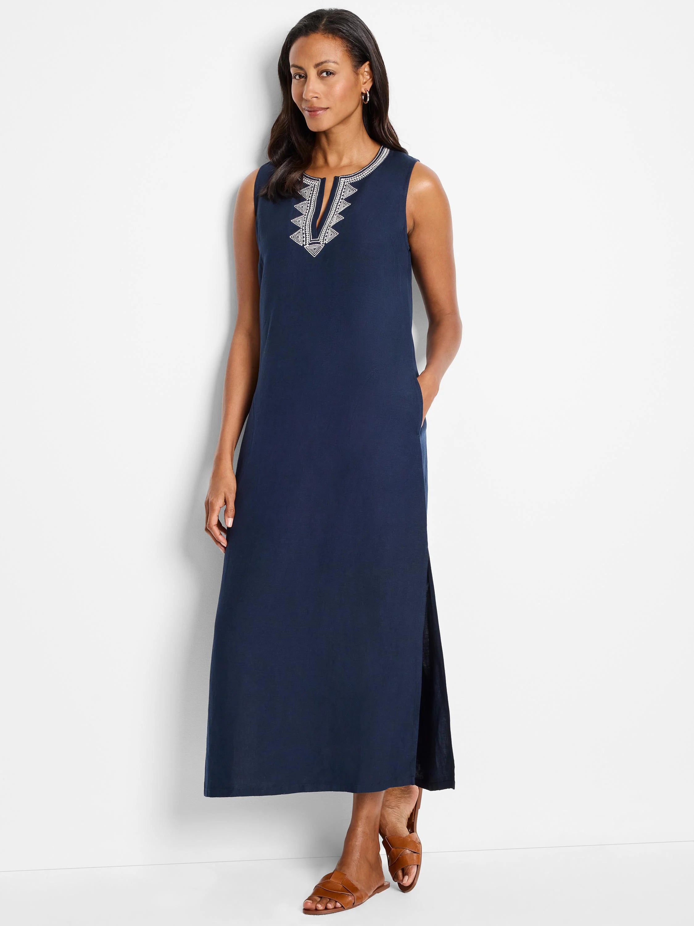 Navy blue maxi dress, sleeveless, V-neck with light gray embroidered detail. Side slits.