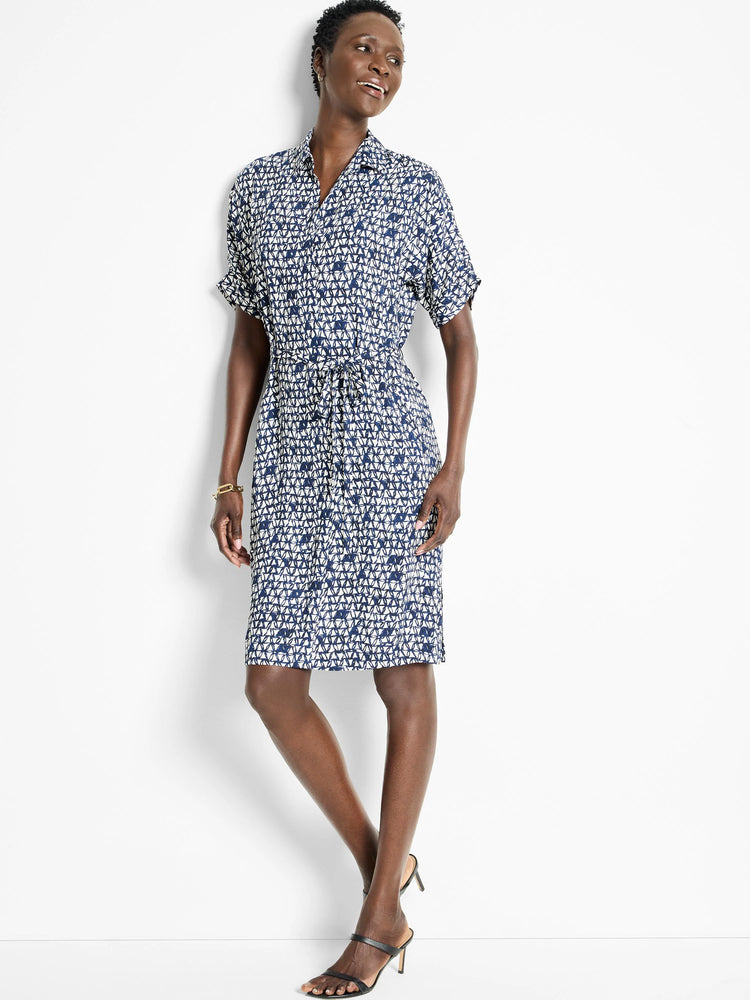 Knee-length belted shirt dress in navy blue and off-white geometric print. Short sleeves, collared neckline.