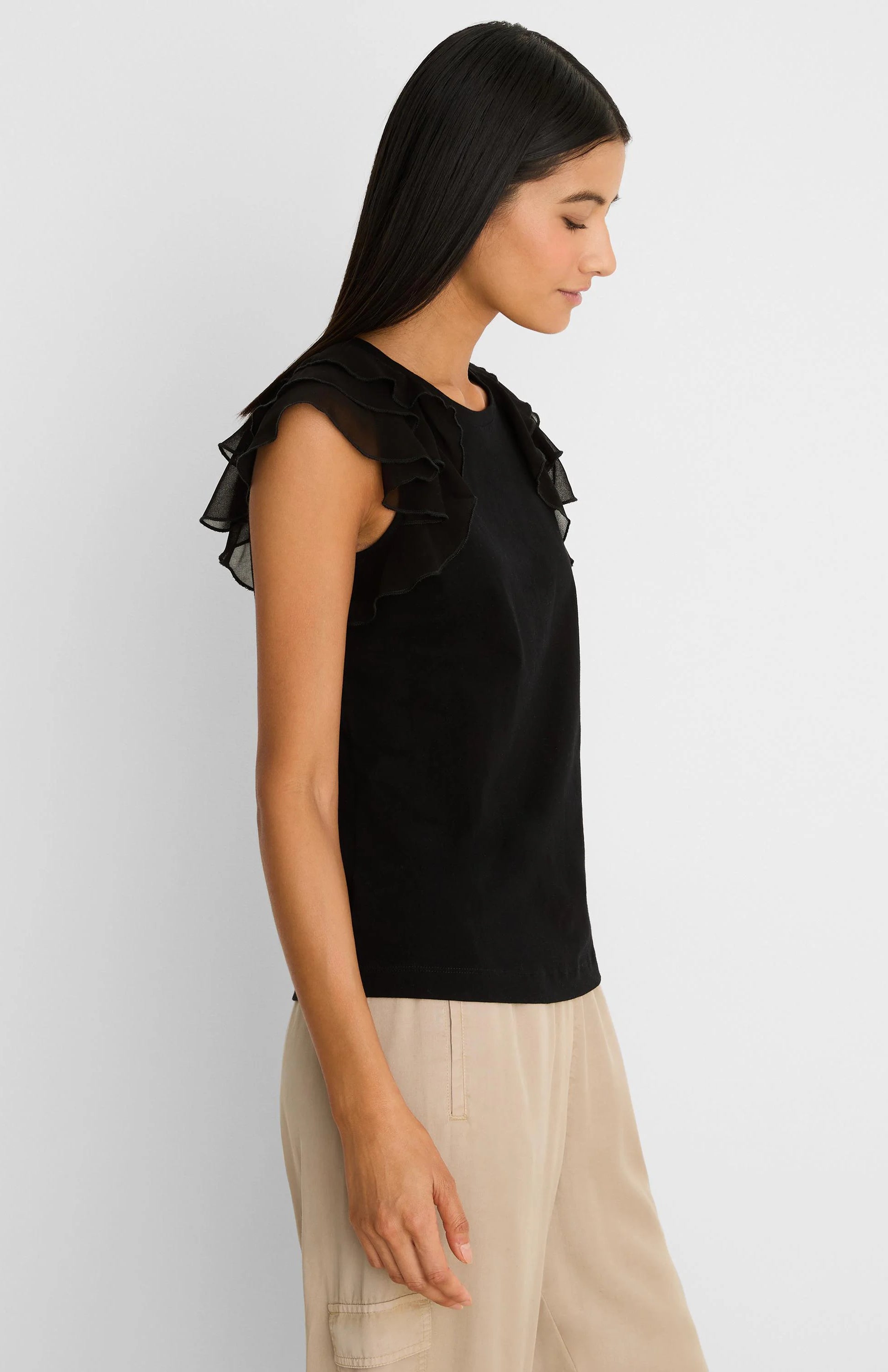 Black top with a round neckline and tiered, sheer ruffled cap sleeves.
