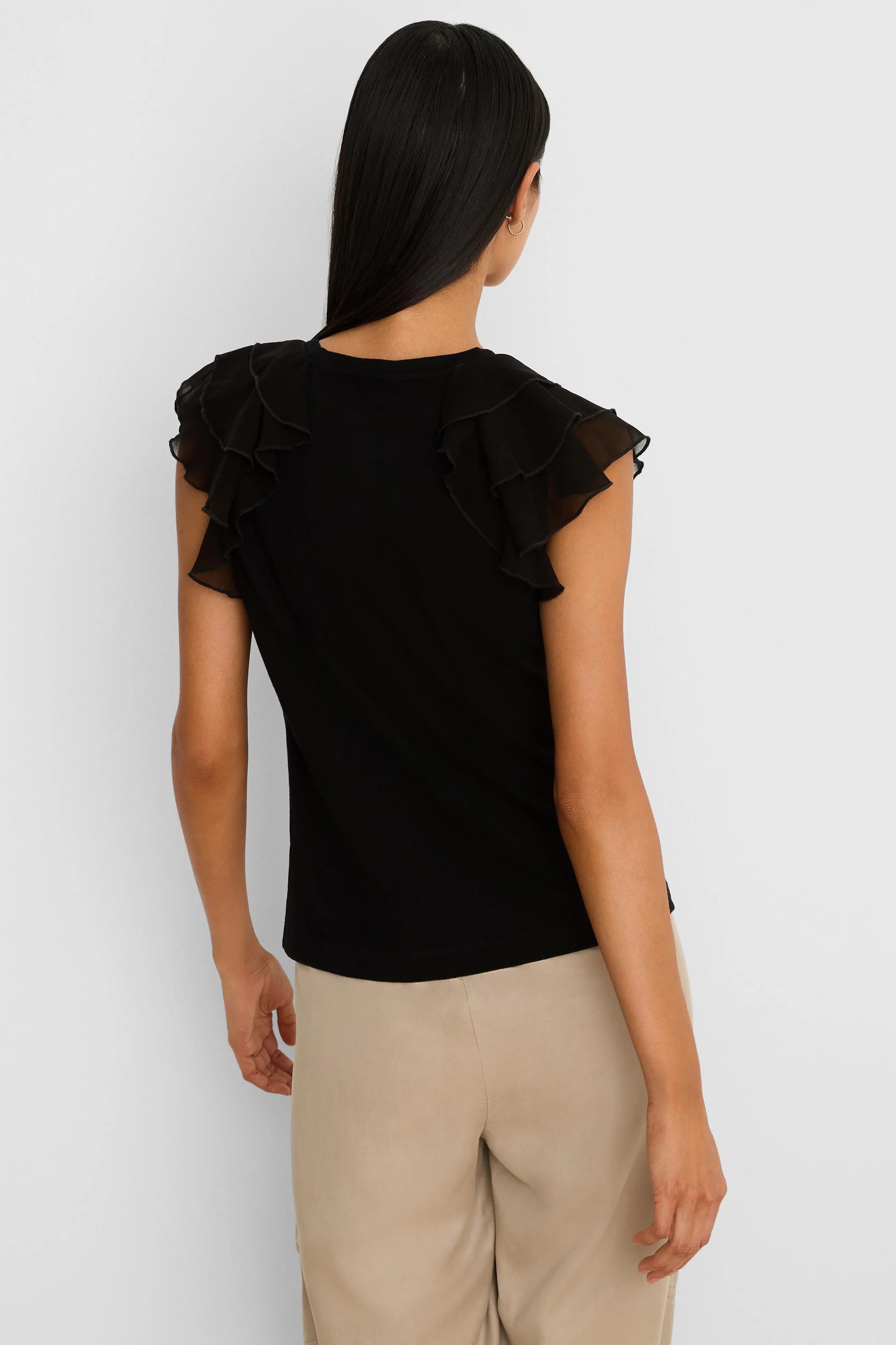 Black top with sheer, layered chiffon ruffle short sleeves, shown from the back.