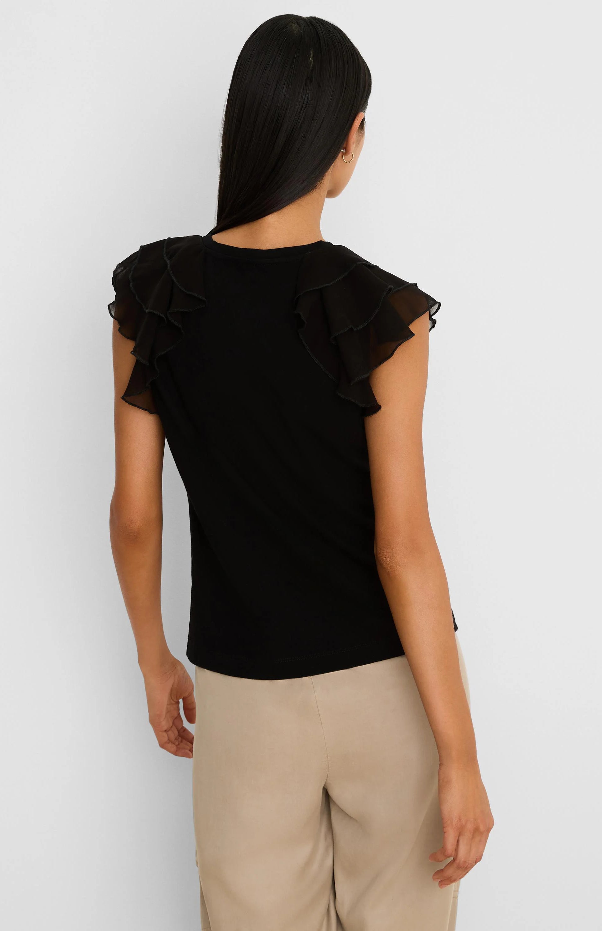 Black top with sheer, layered chiffon ruffle short sleeves, shown from the back.