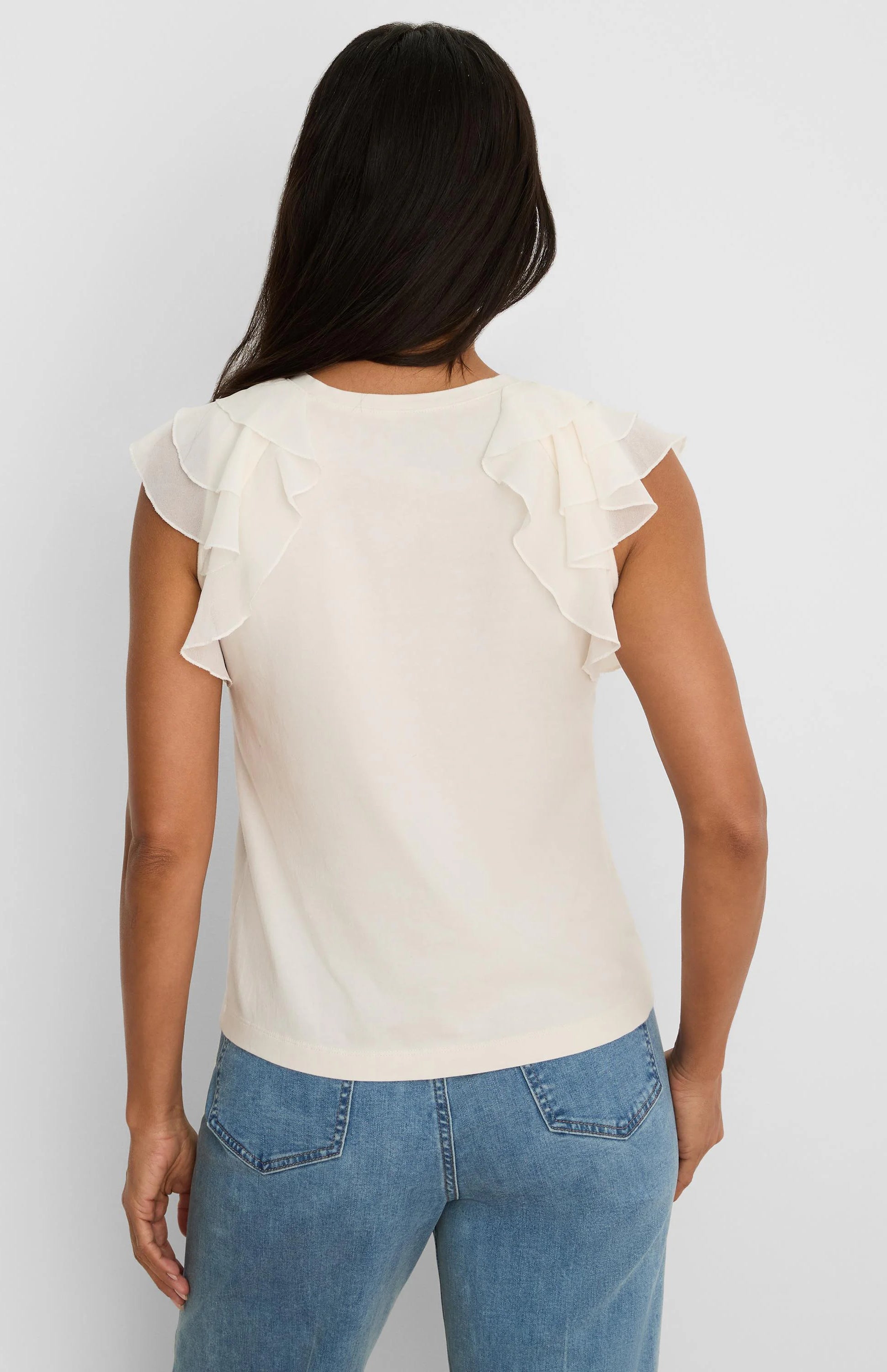 Light cream top, back view, with a round neckline and layered chiffon ruffle sleeves.