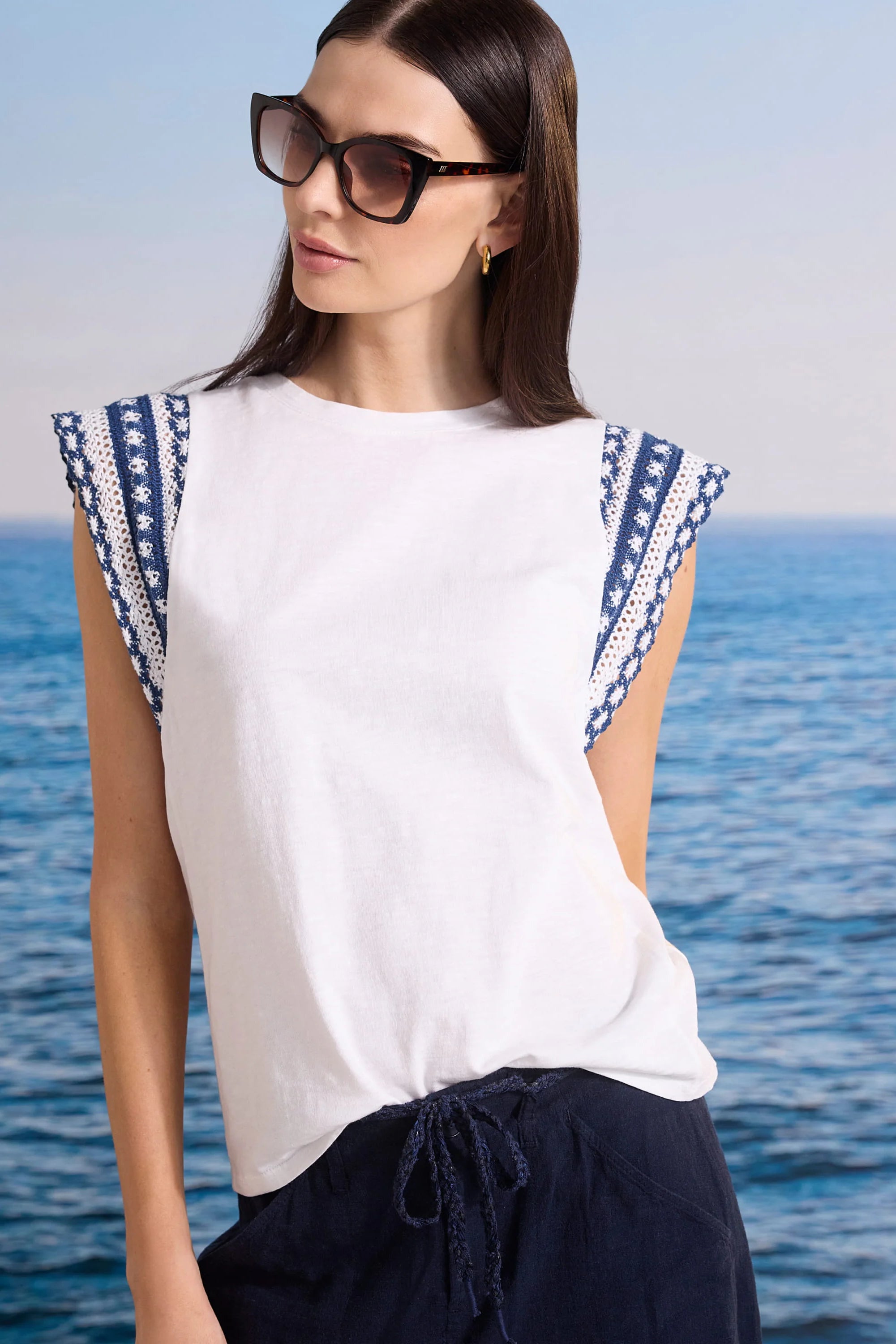 White cotton slub top with patterned navy and white knit trim cap sleeves.