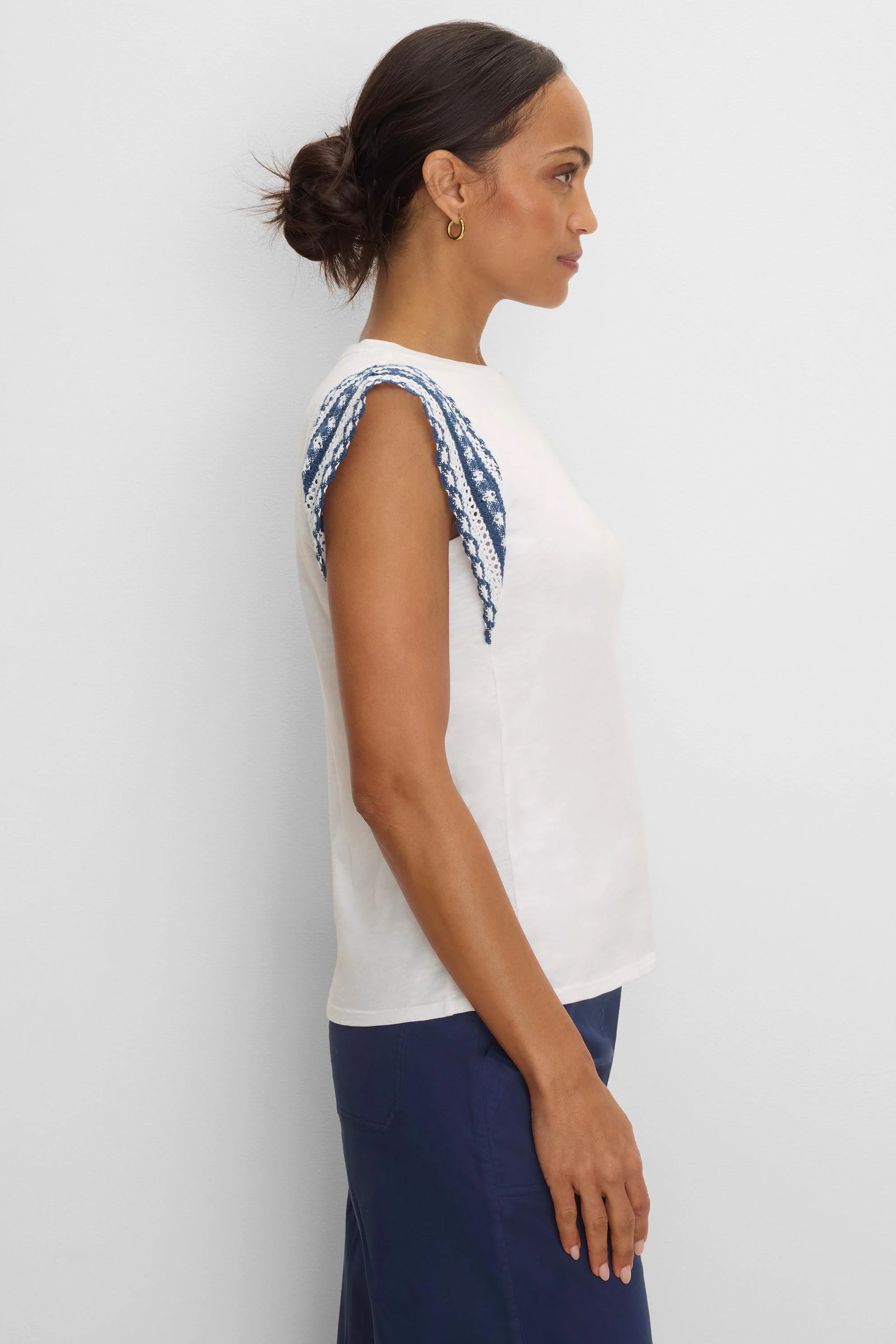 Cream cotton slub top with blue and white patterned knit trim on the shoulders.