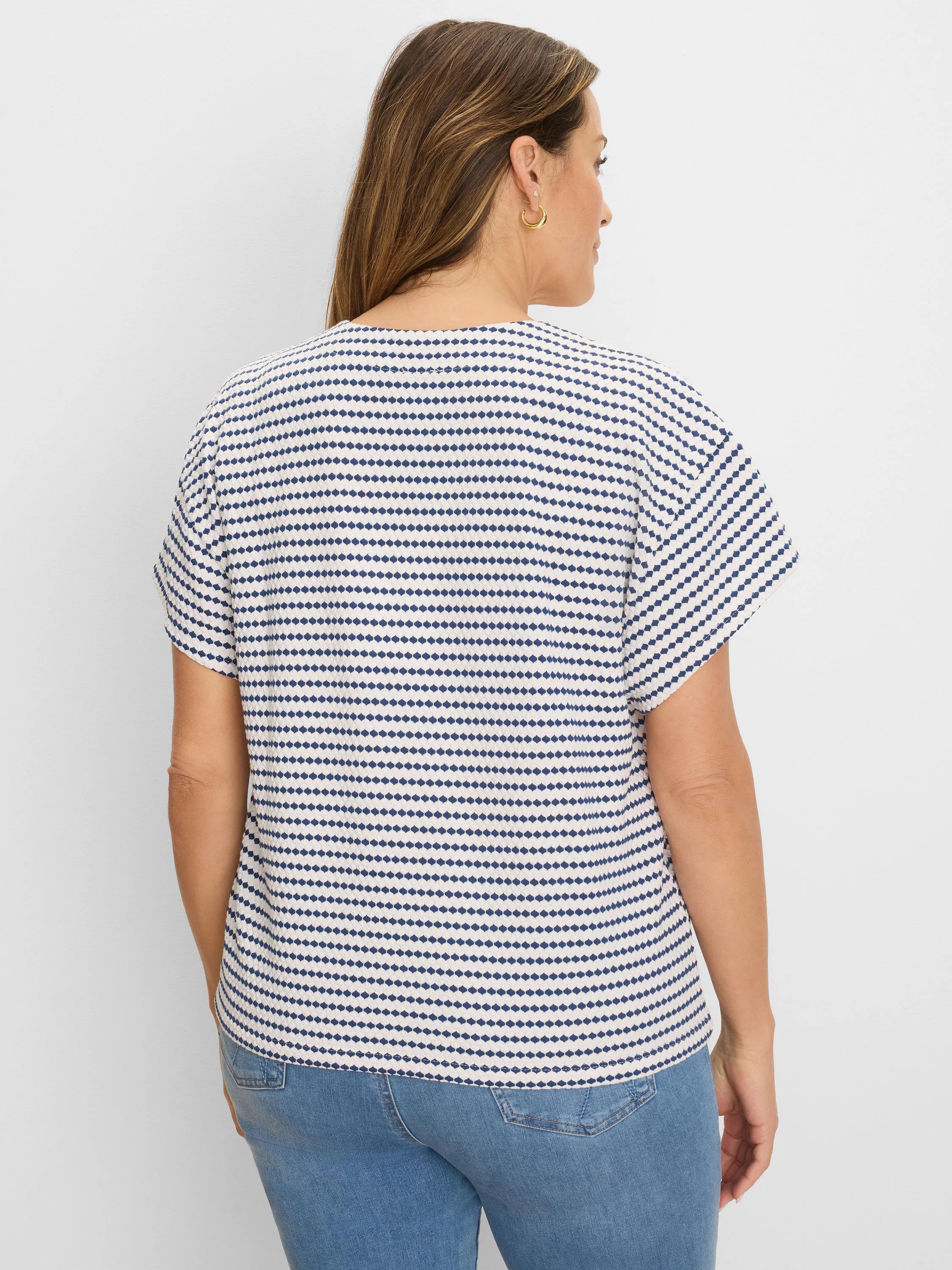 Off-white short-sleeve top with textured navy diamond horizontal stripes.