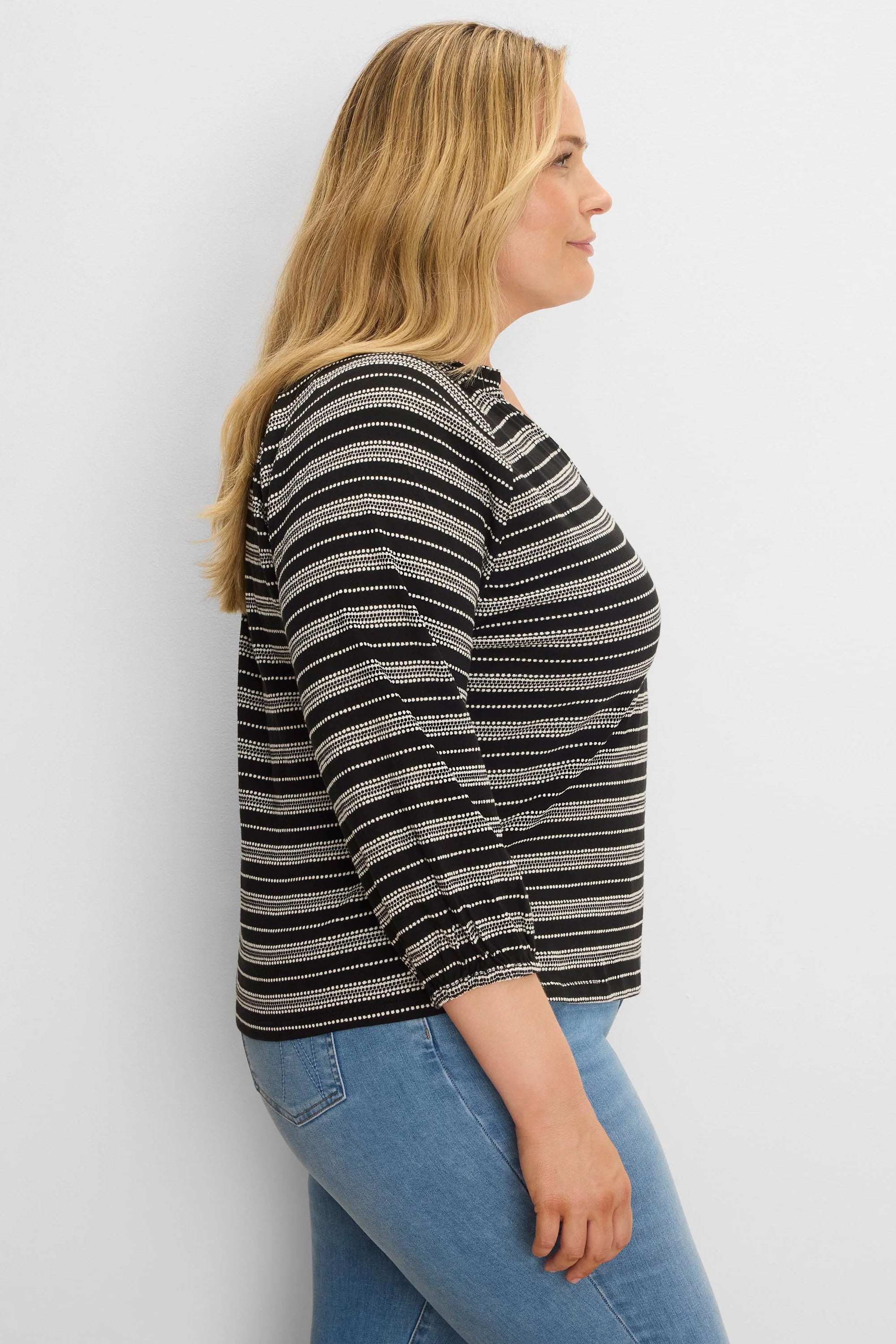Black and off-white knit top with horizontal dotted stripes and elasticized 3/4 length sleeves.
