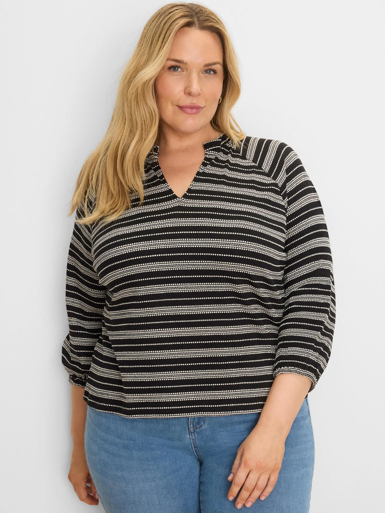 Black and white knit top with mixed horizontal stripes (solid & dotted), a split V-neck, and 3/4 sleeves.