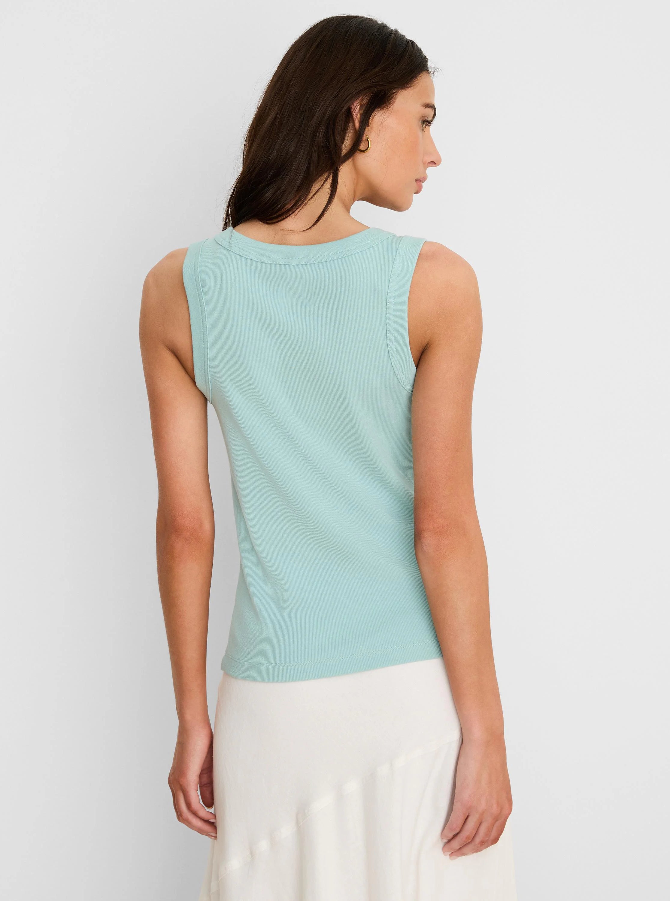 Aqua ribbed knit tank on model, back view with rounded neckline.
