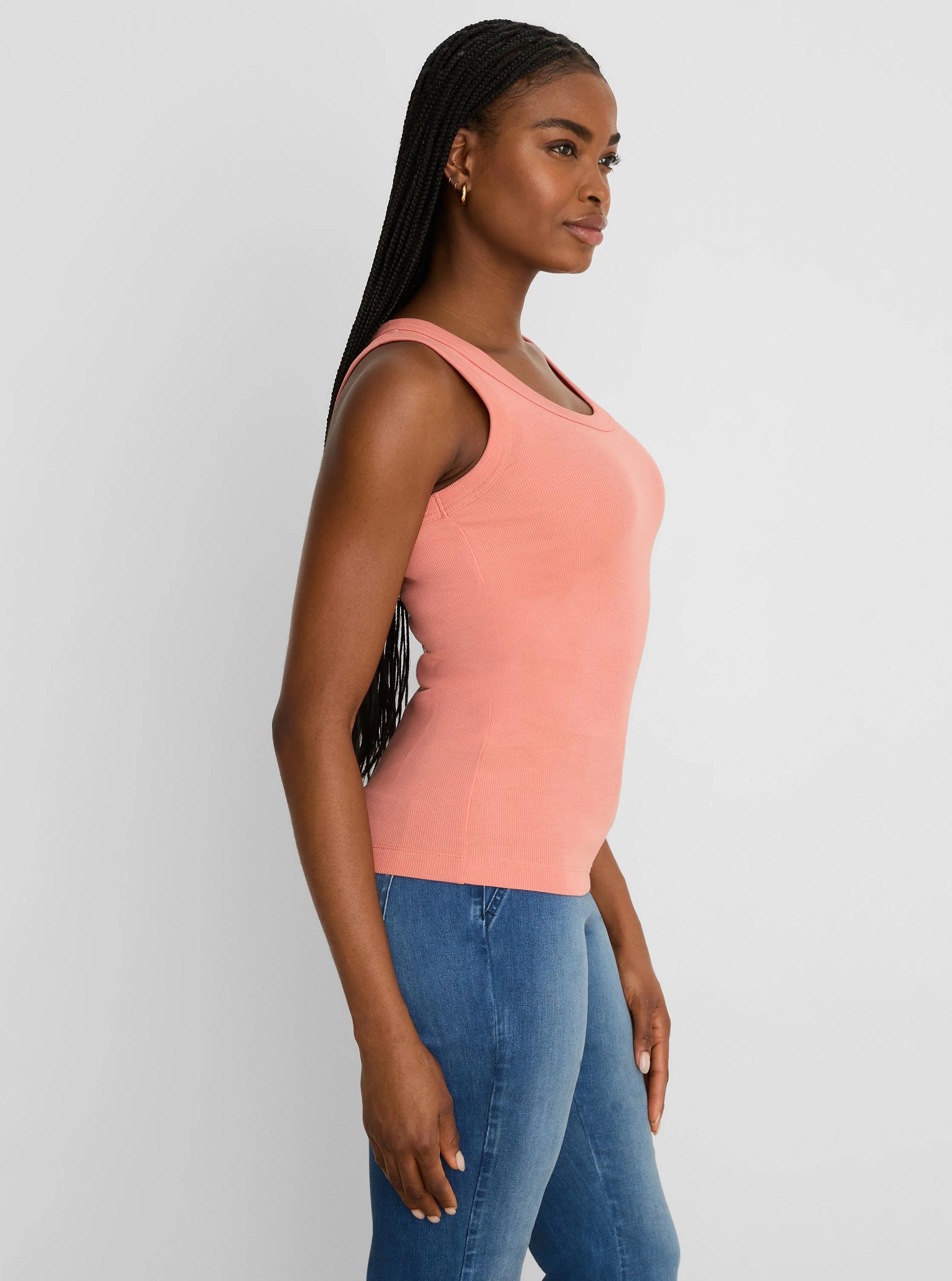Form-fitting peach ribbed knit scoop neck tank top.