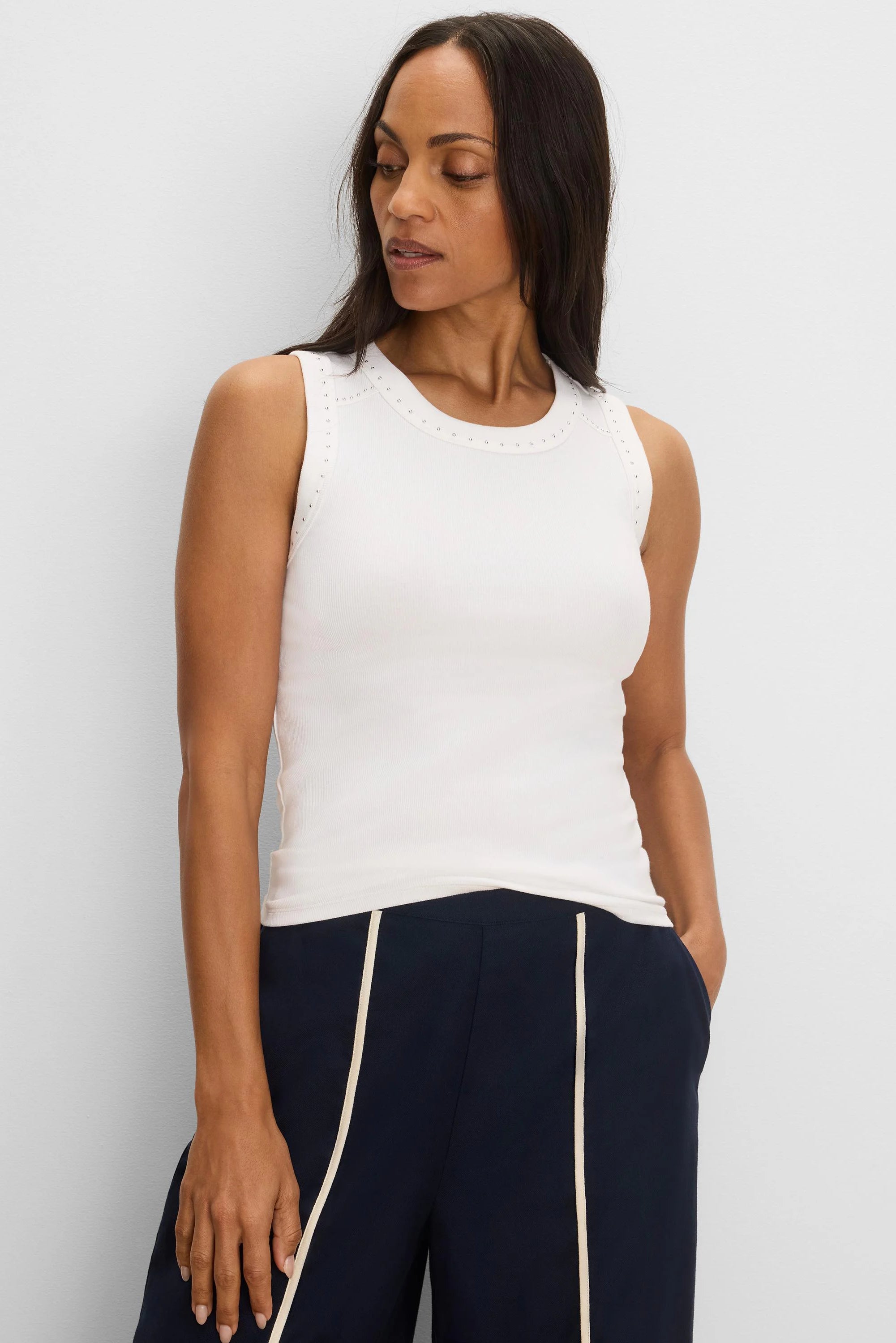 Cream rib knit tank with small silver studs along its round neckline and shoulders.