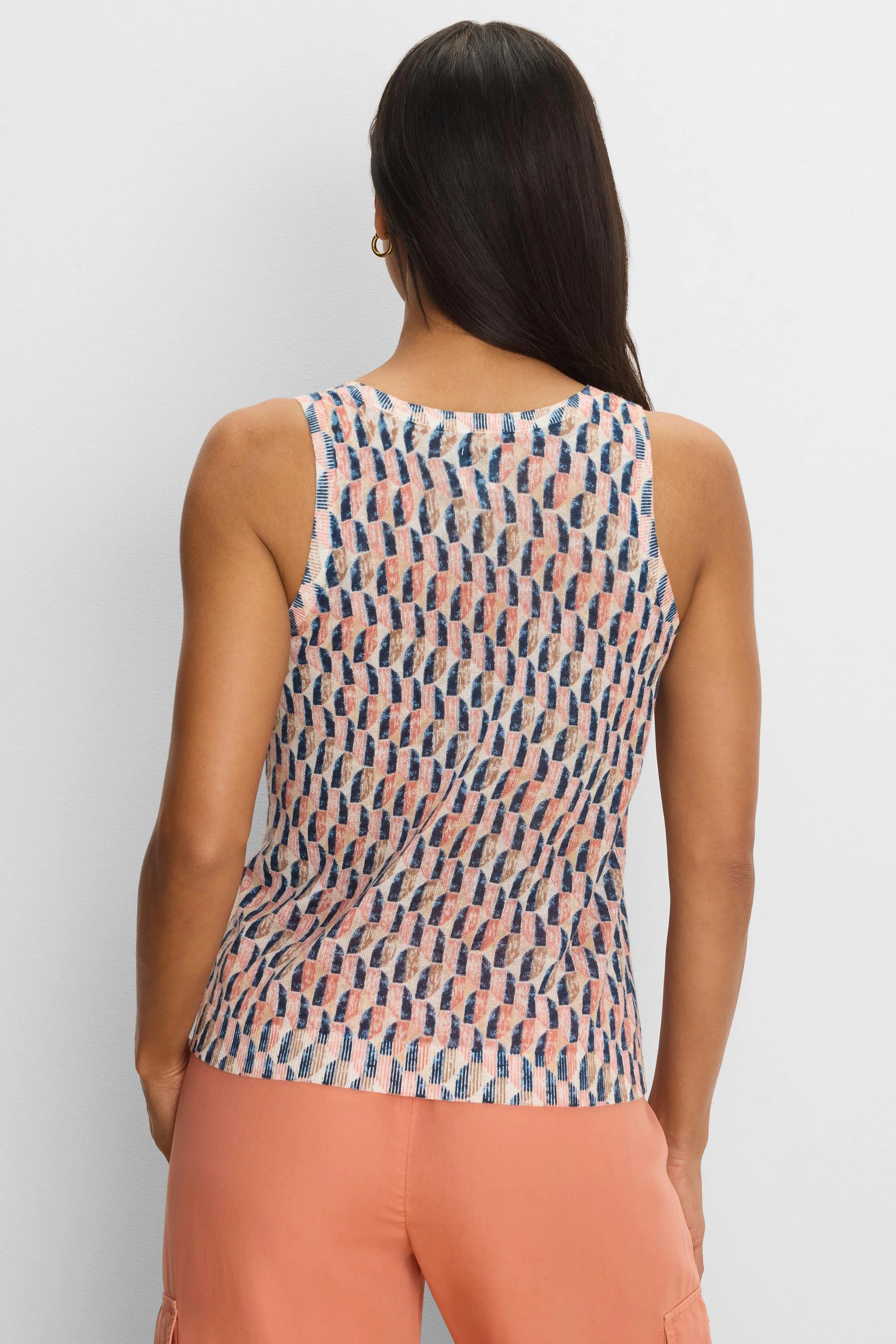Sleeveless sweater tank with abstract navy, peach, and tan brushstroke pattern on a cream background.