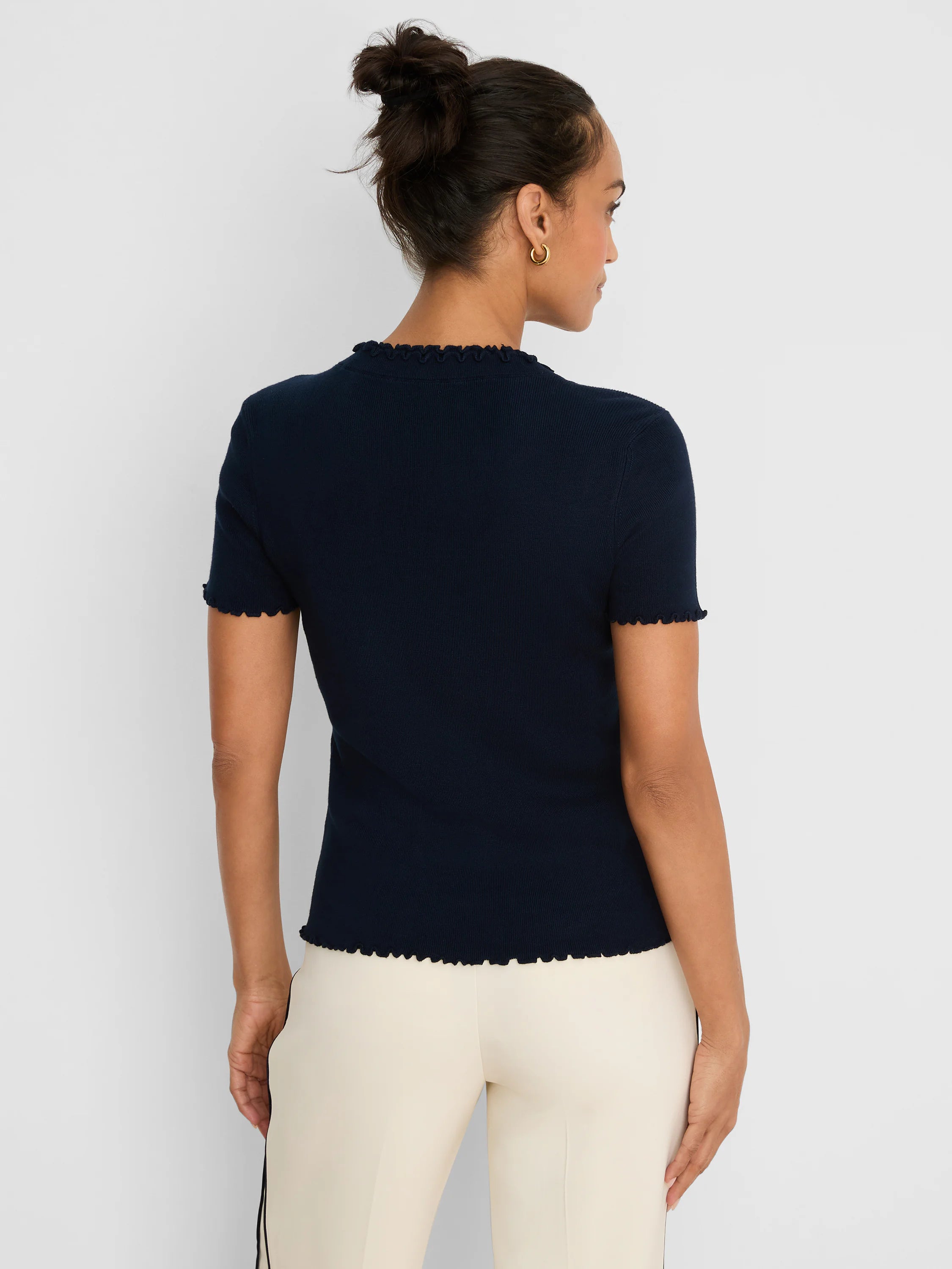 Dark blue ribbed sweater tee with short sleeves and ruffle trim on the neck, sleeve cuffs, and bottom hem.