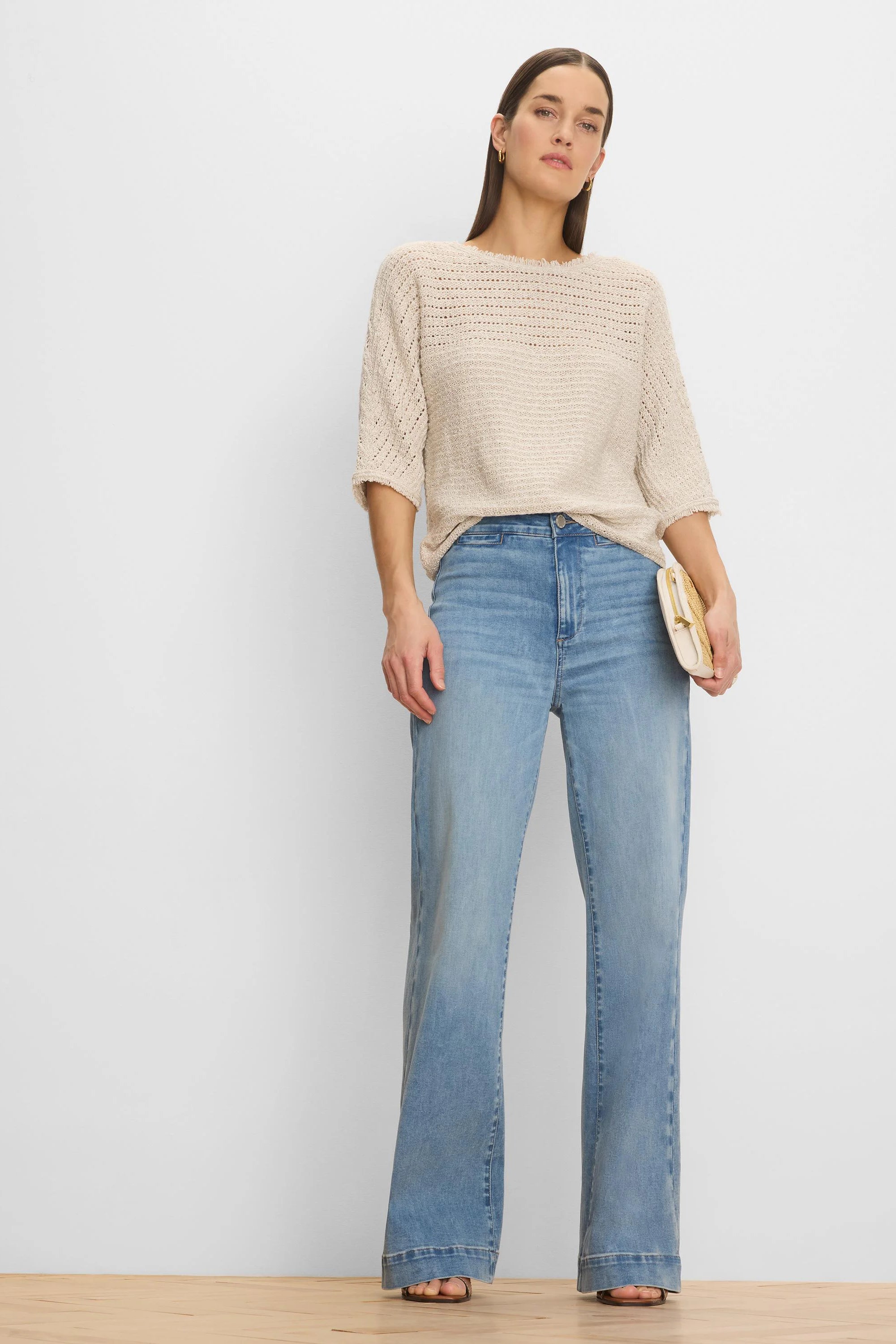 Loose beige open-knit sweater with varied textures, 3/4 sleeves, and a wide neckline.