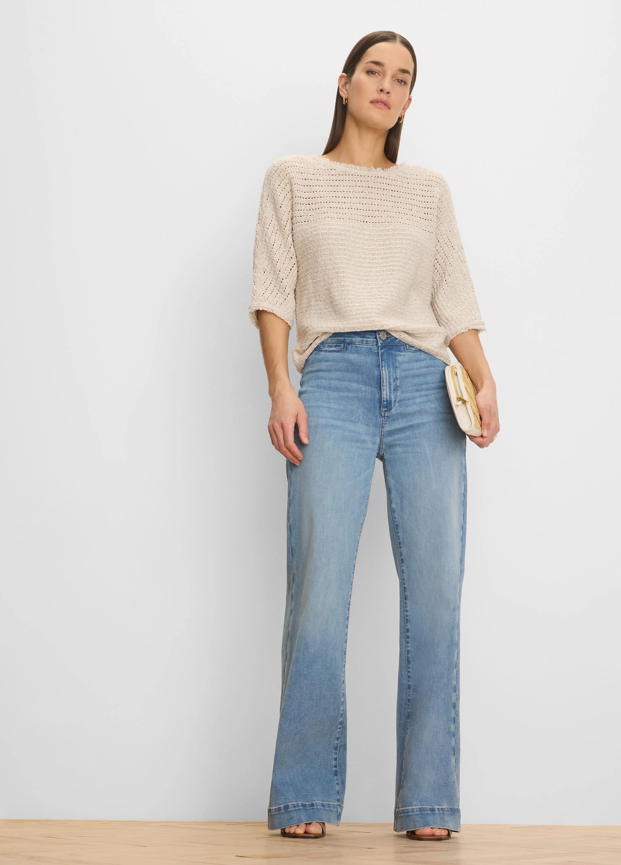 Loose beige open-knit sweater with varied textures, 3/4 sleeves, and a wide neckline.