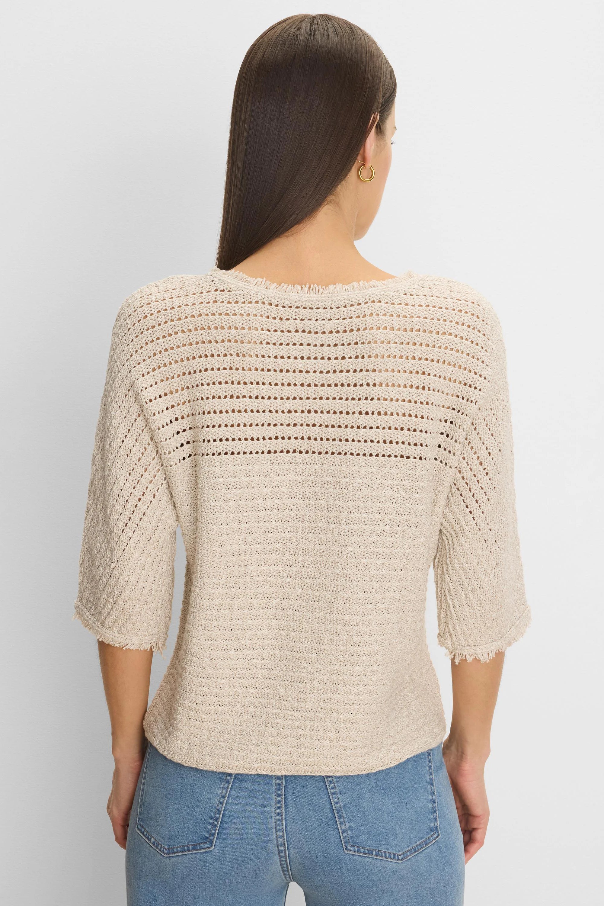 Light beige open-knit sweater with horizontal textured stripes, wide frayed neckline, and 3/4 sleeves.