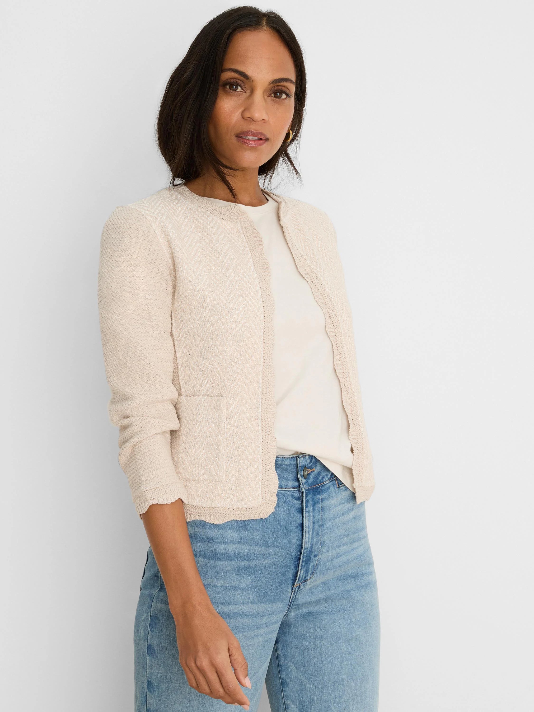 Light beige open-front knit jacket with chevron pattern, scallop trim, and patch pockets.