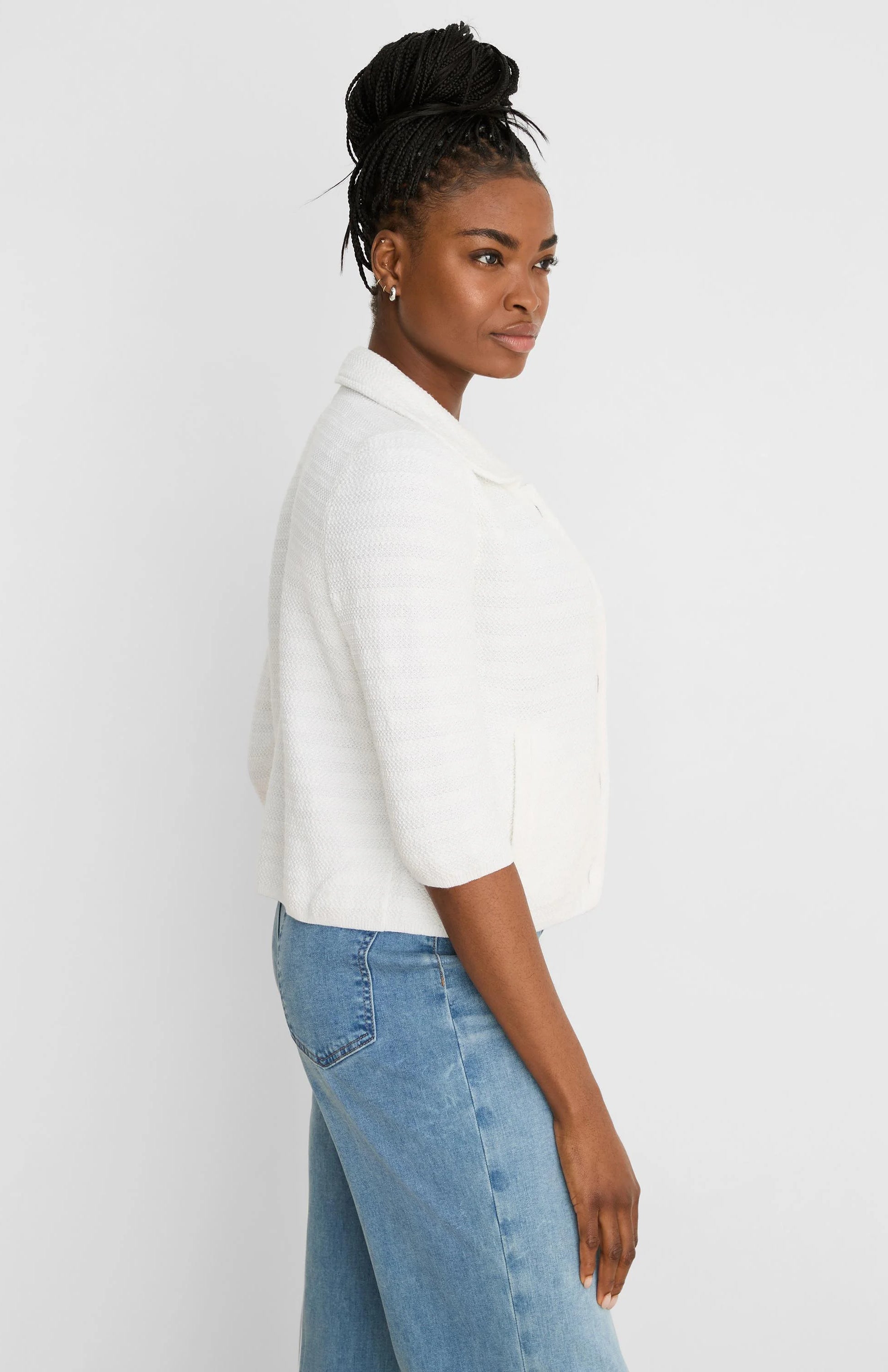 White elbow-sleeve textured knit jacket with a collar.