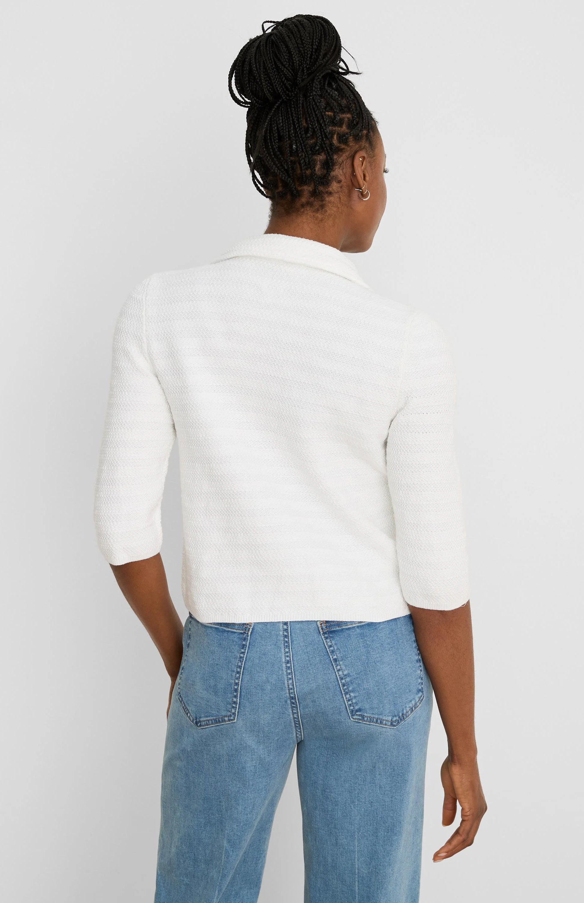 White textured knit jacket with elbow sleeves and collar, worn from behind.