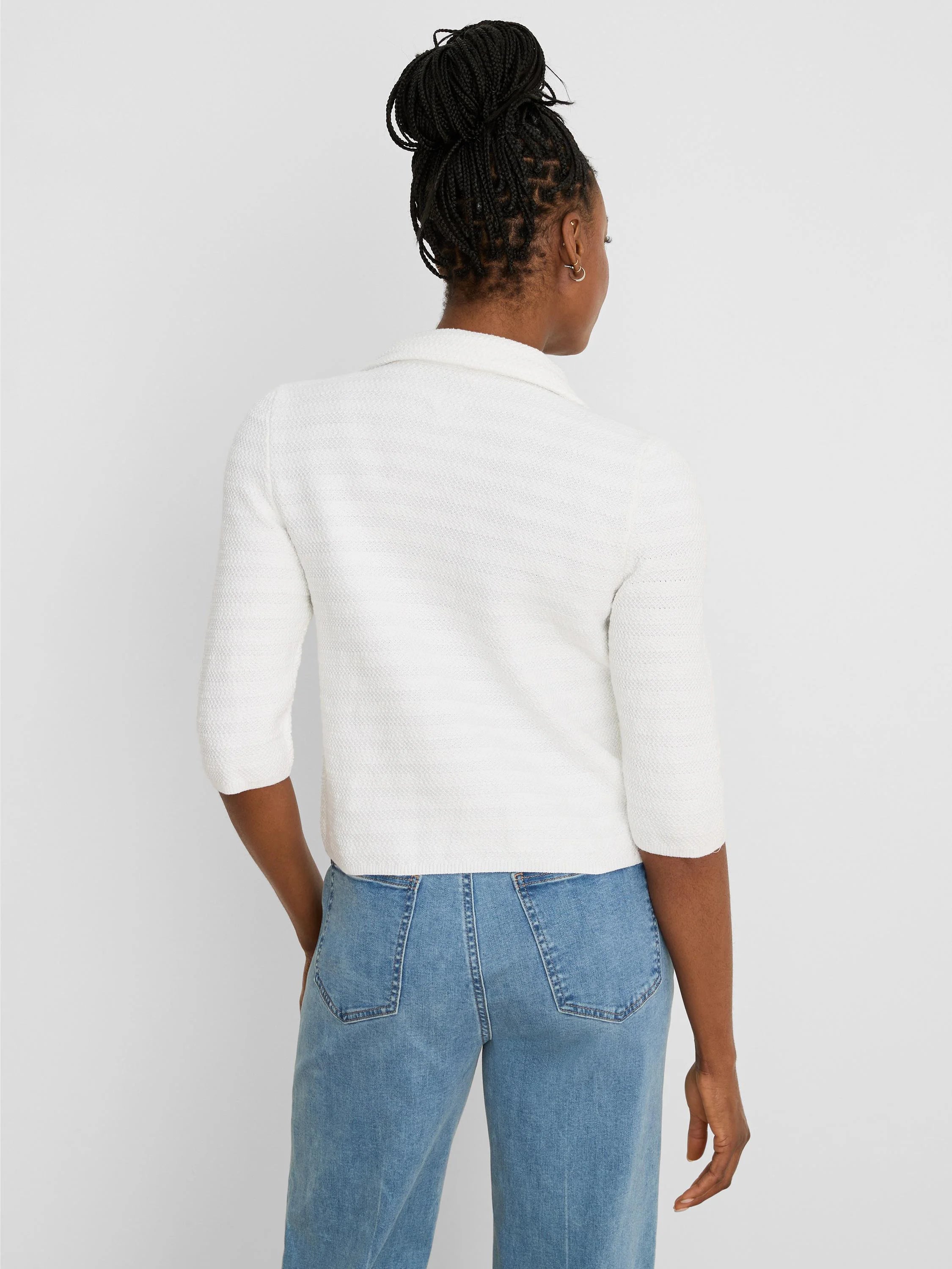 White textured knit jacket with elbow sleeves and collar, worn from behind.