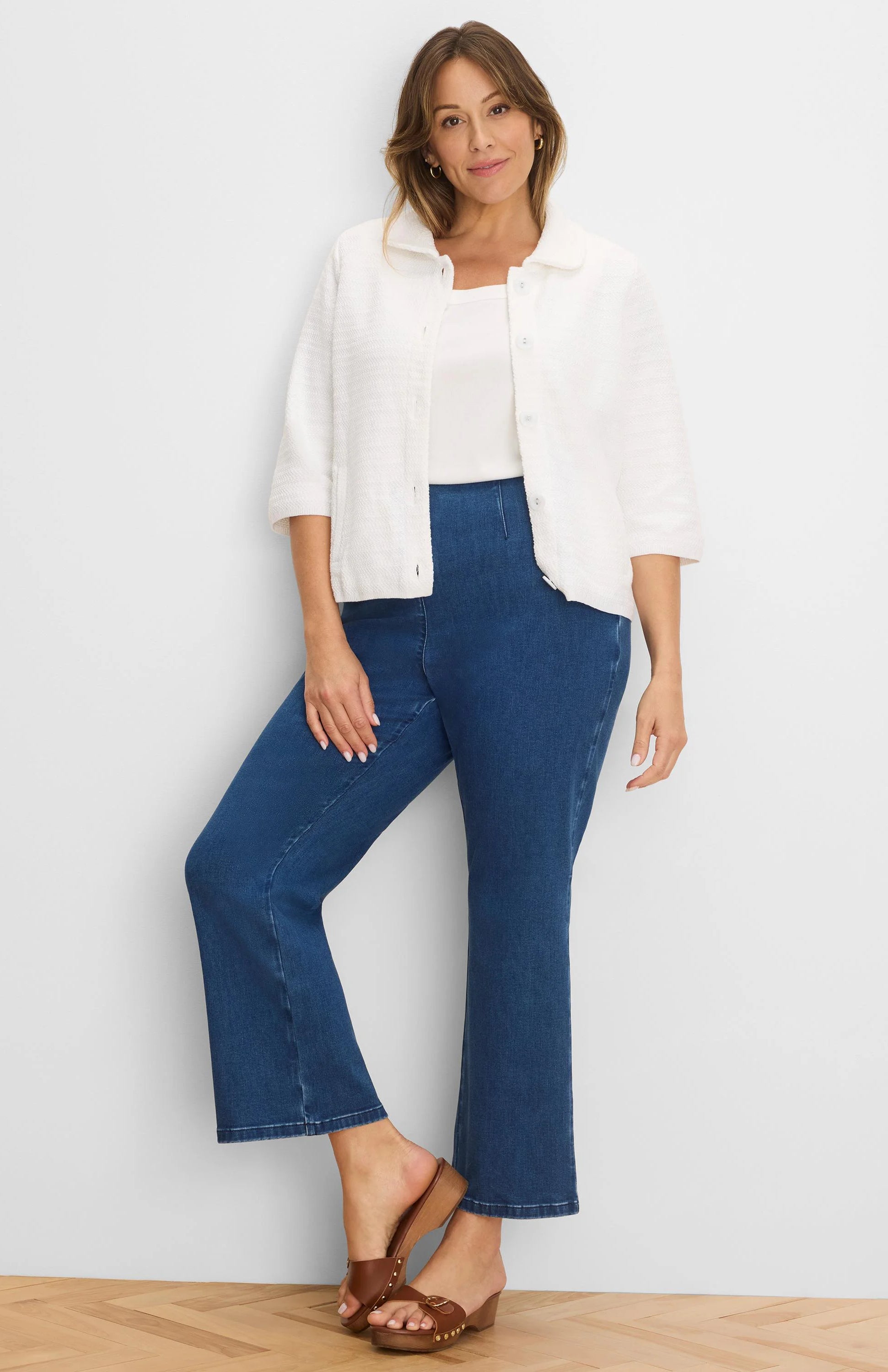 White textured knit jacket with elbow sleeves and front buttons.