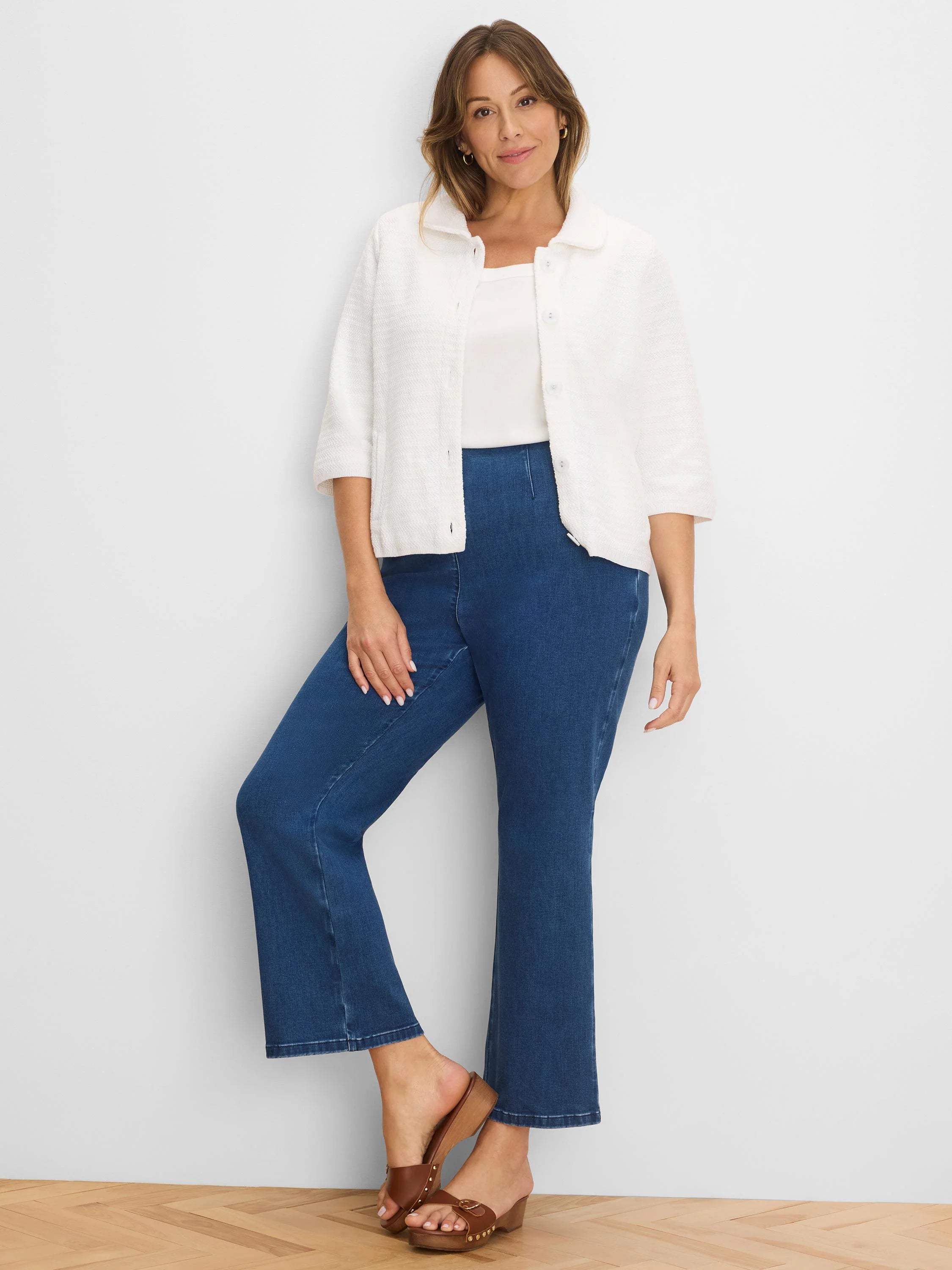 White textured knit jacket with elbow sleeves and front buttons.