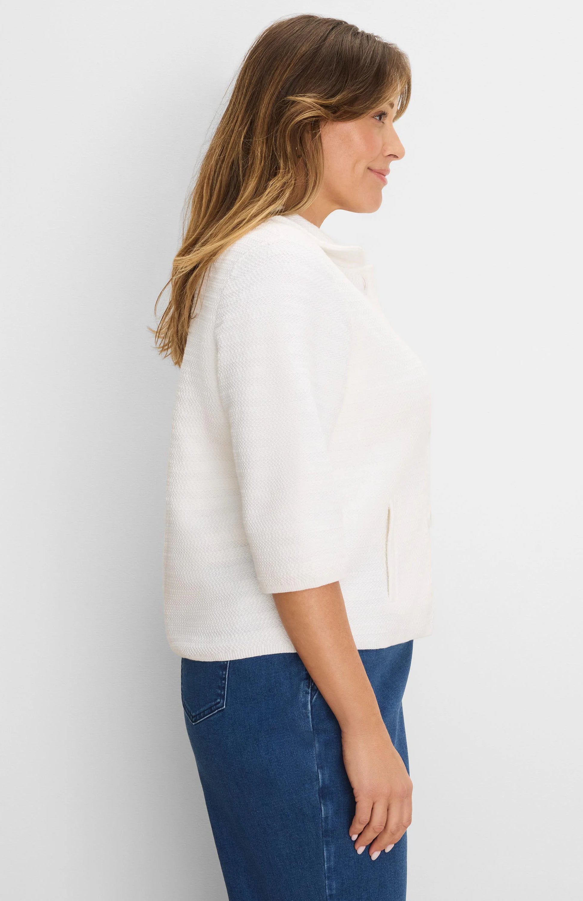Cream textured knit jacket with elbow sleeves, band collar, and subtle side pockets.