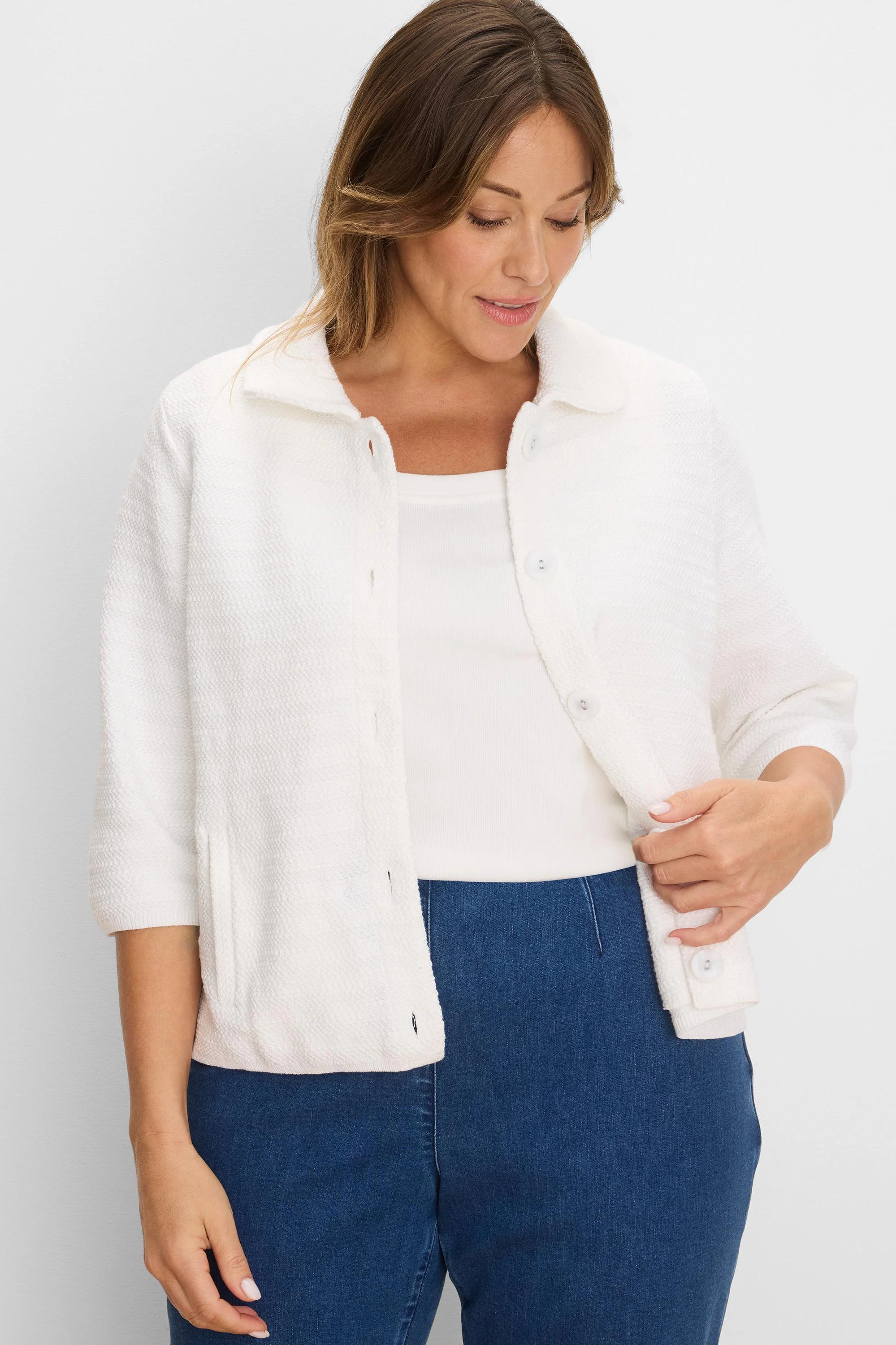 White, collared, textured knit jacket with elbow sleeves, button-front, and front patch pockets.