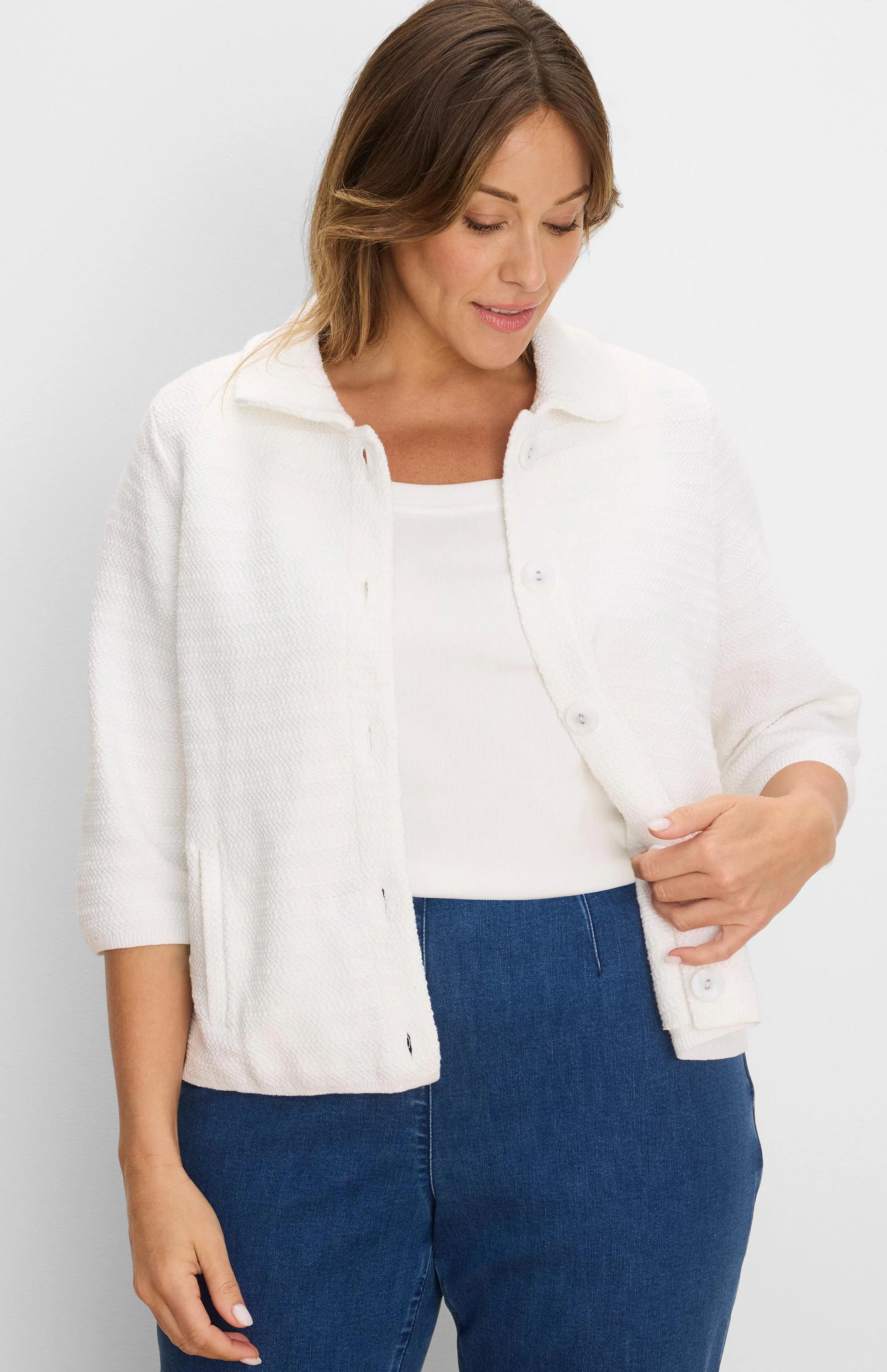 White, collared, textured knit jacket with elbow sleeves, button-front, and front patch pockets.
