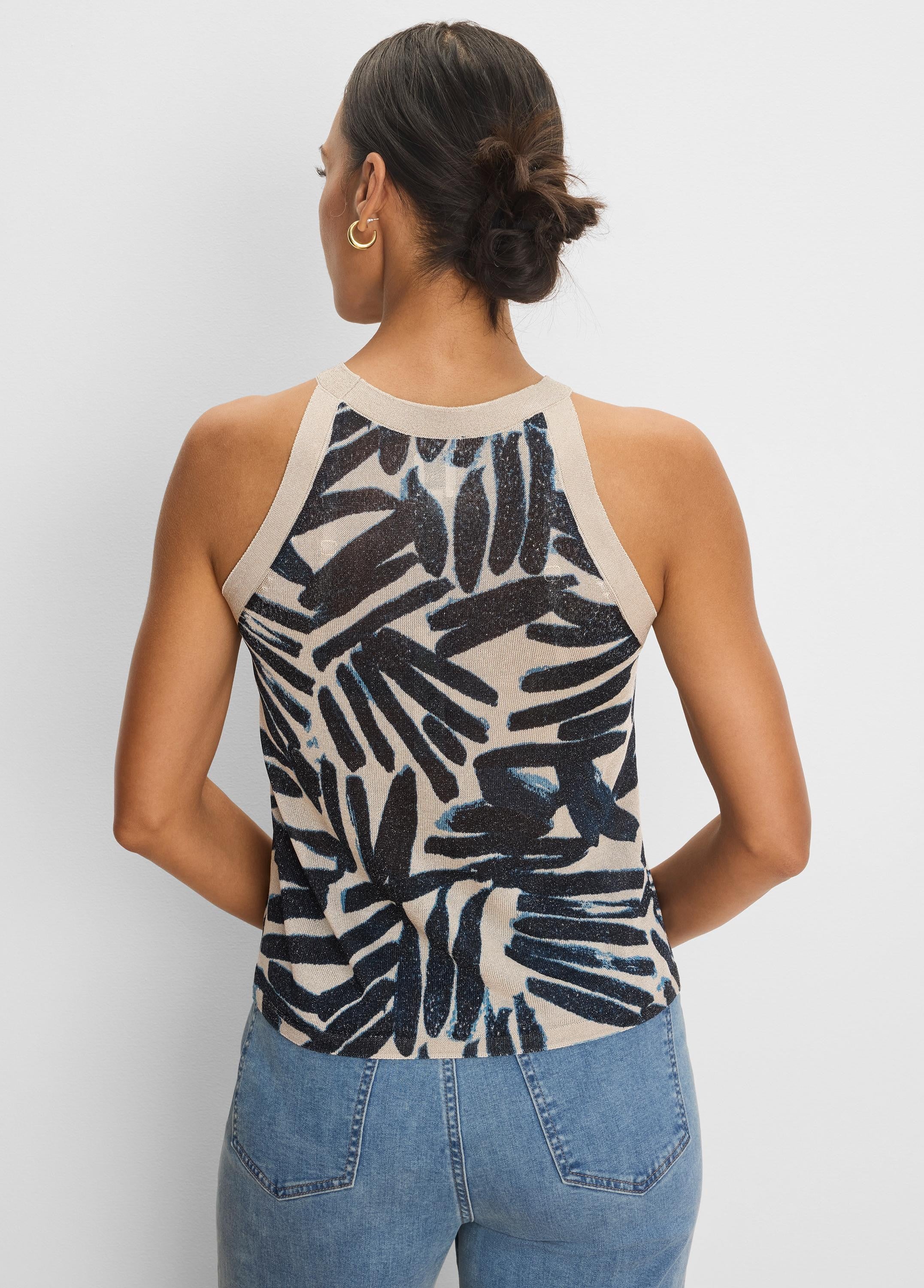 Beige knit tank with dark blue painted palm pattern. Ribbed beige neck and armholes. Back view.