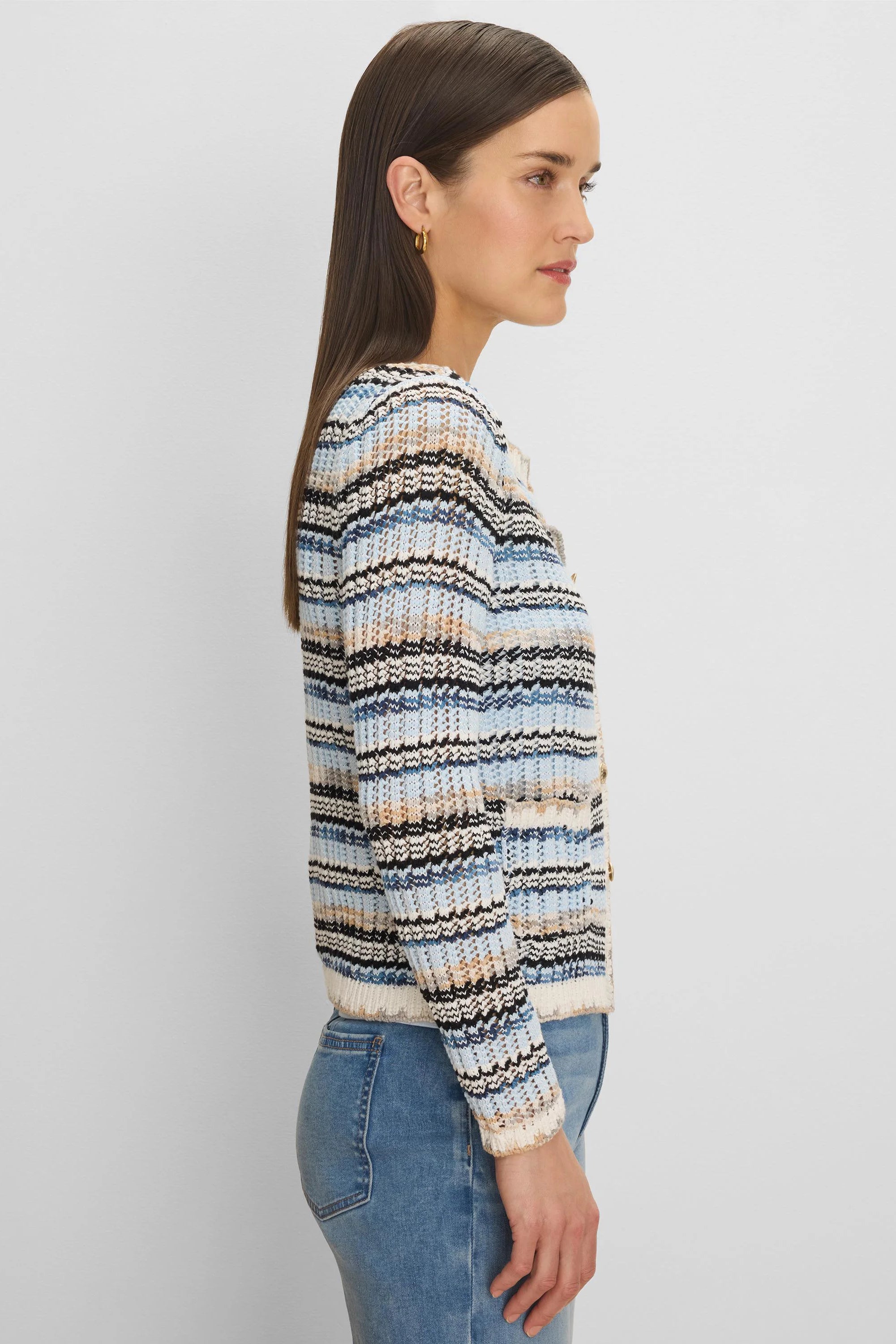 Open-knit cardigan with blue, cream, black, and tan horizontal stripes. Gold buttons visible.