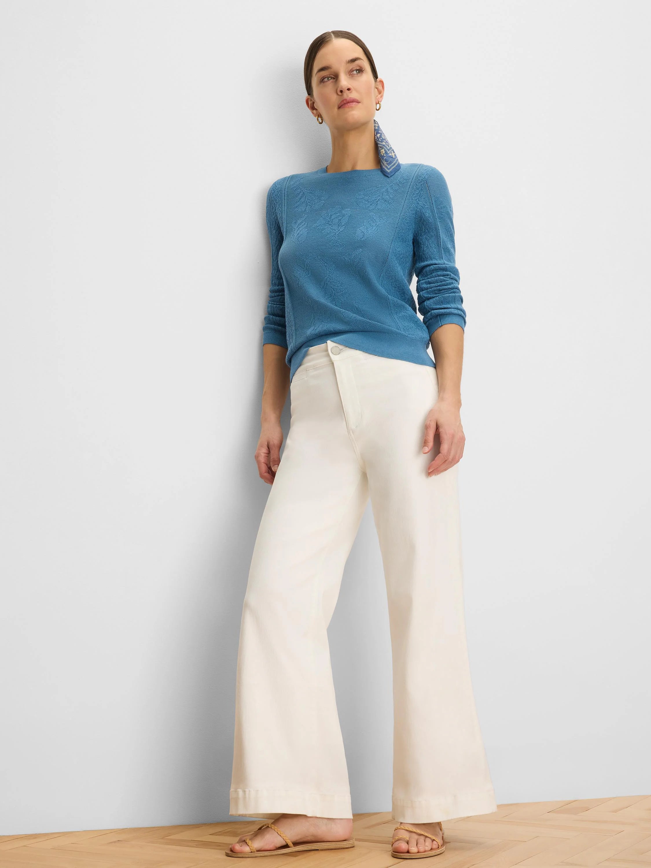 Teal blue sweater with an all-over jacquard lace knit pattern.