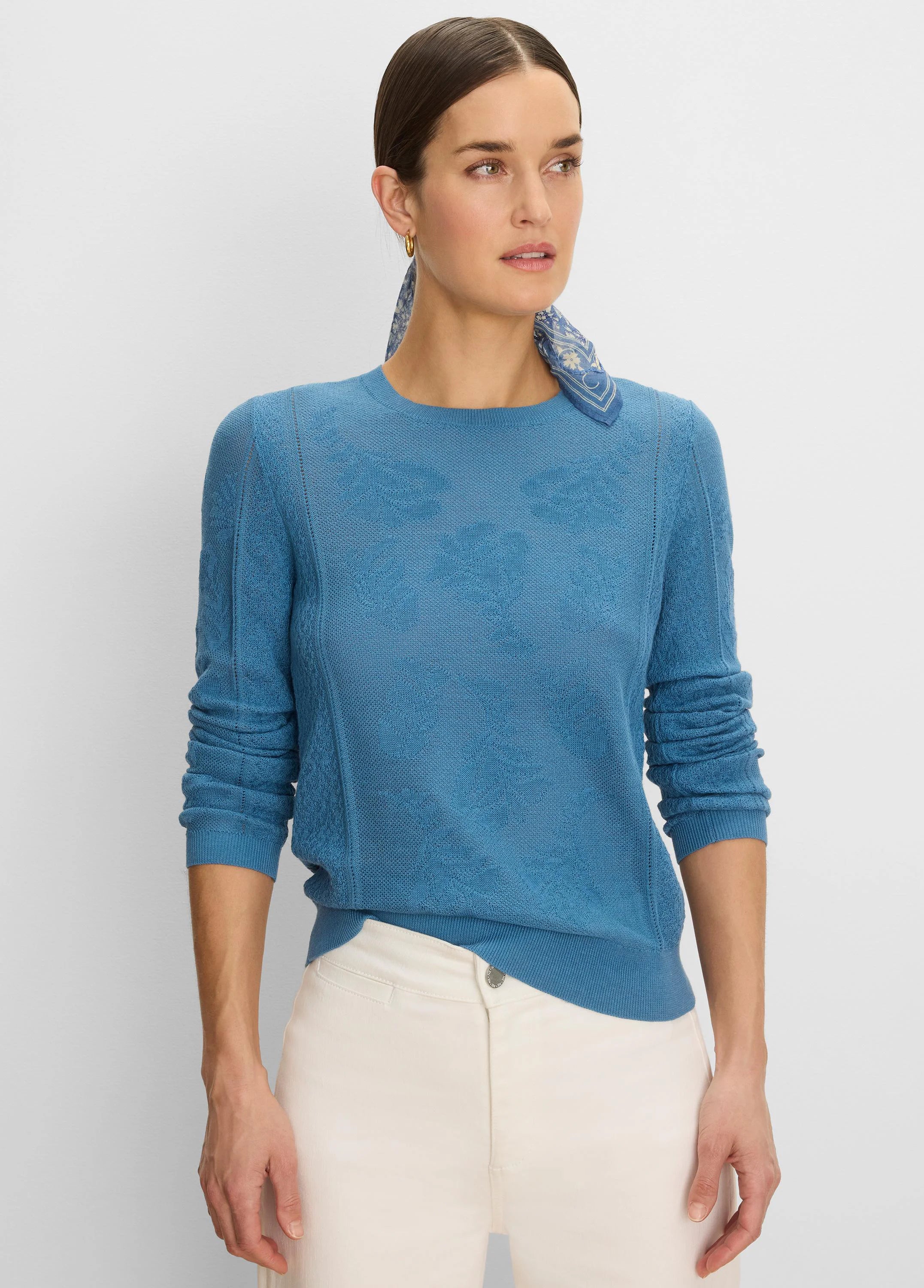 Teal blue sweater featuring a subtle floral jacquard knit.