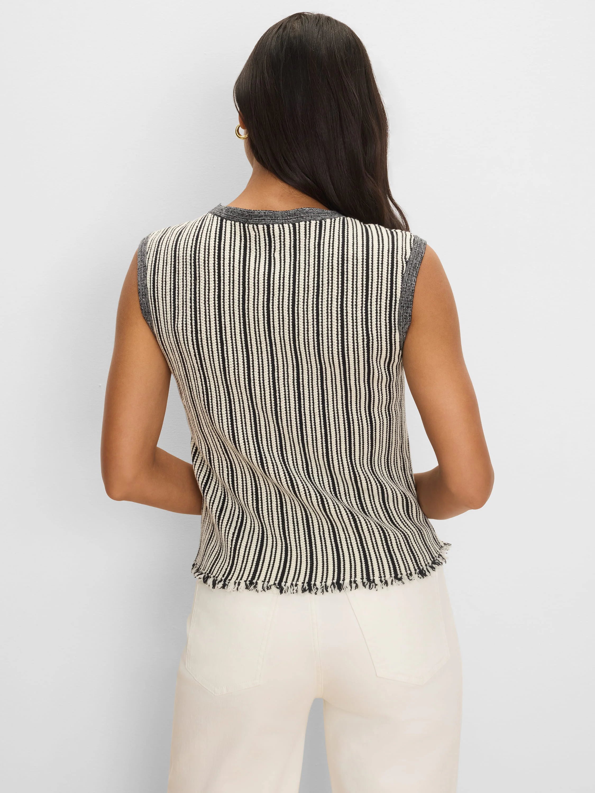 Sleeveless sweater with alternating cream & black vertical stripes, dark grey ribbed trim, and a frayed hem.