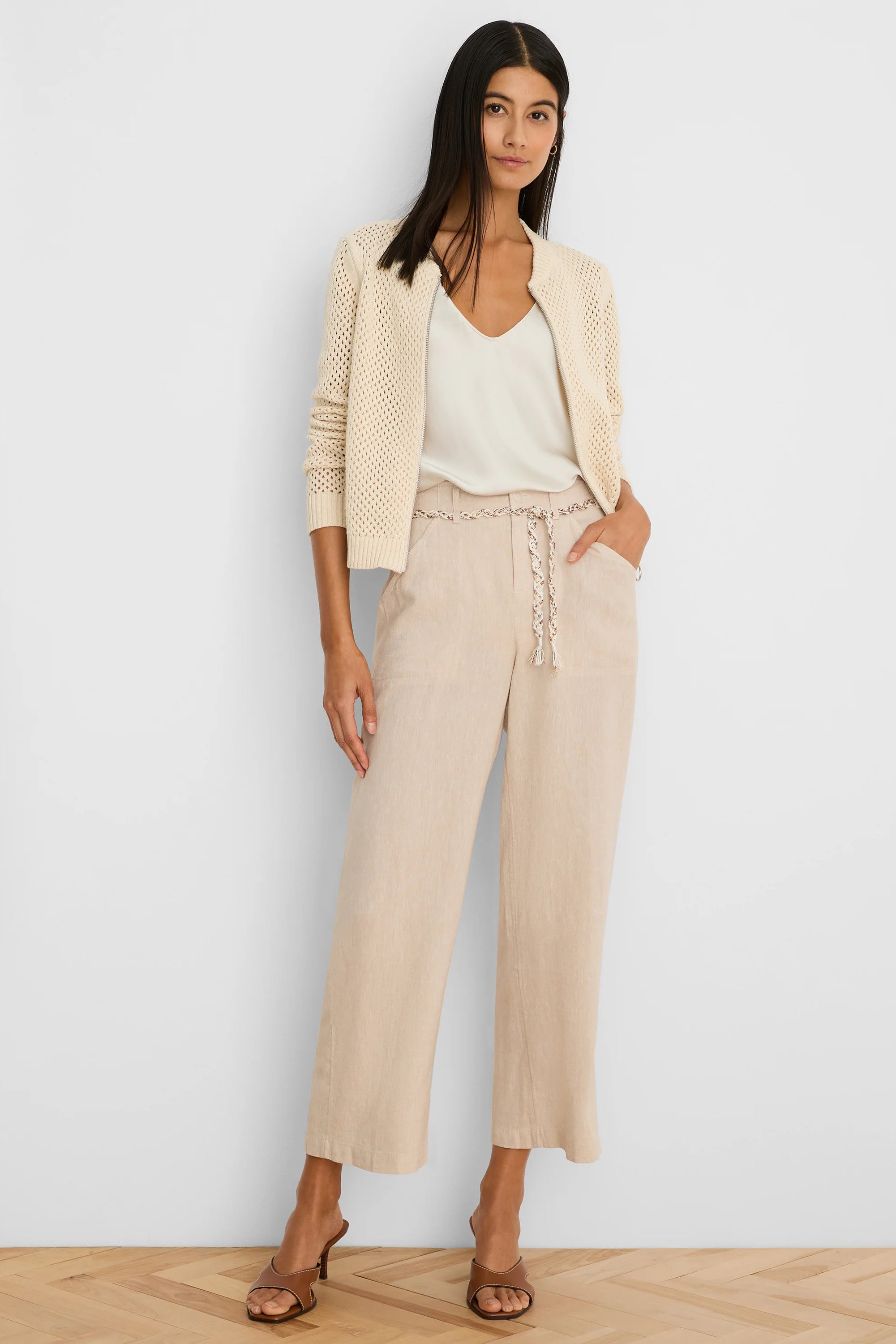 Cream zip-front mesh cardigan.
