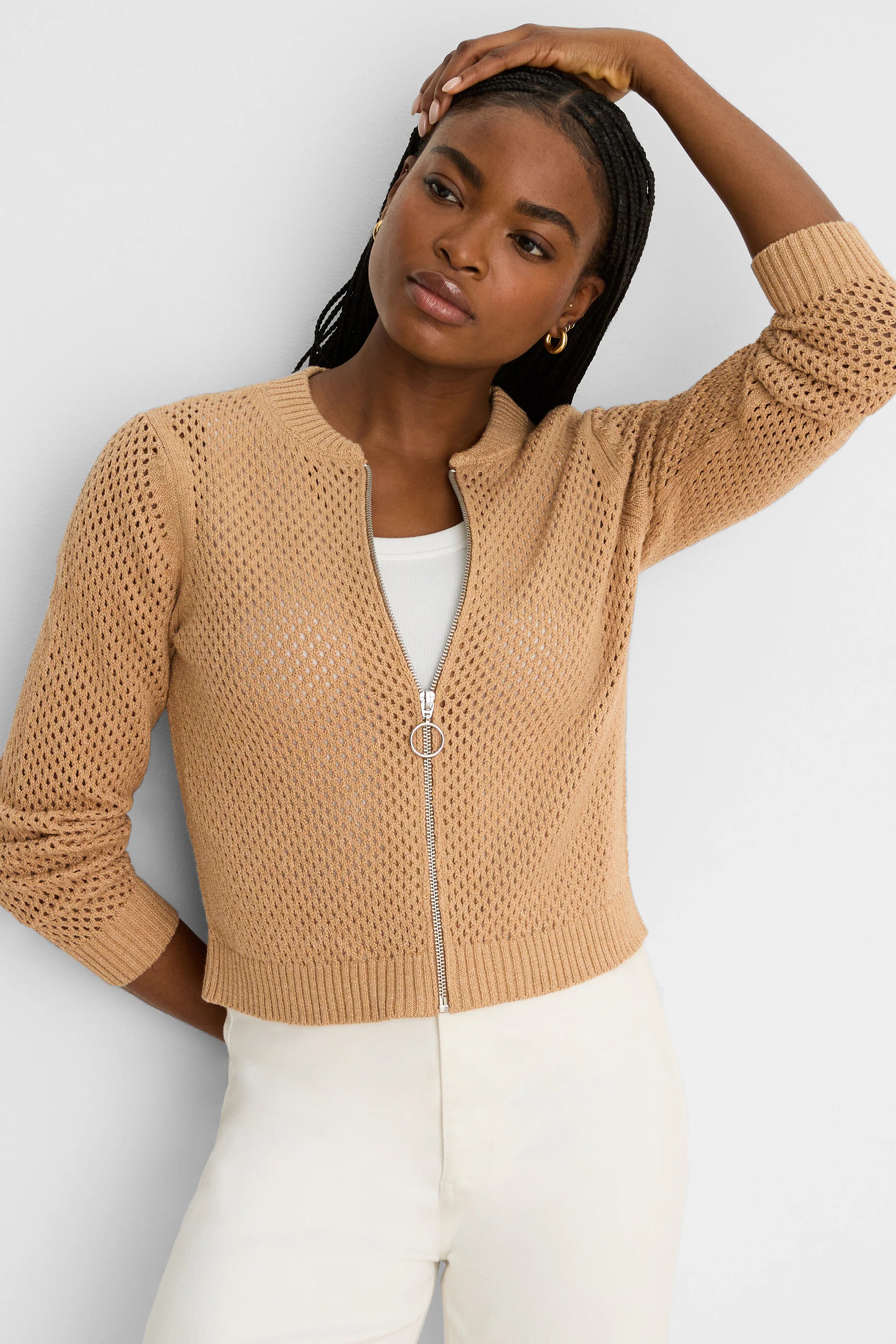 Tan mesh knit cardigan with ribbed trim. Features full silver zipper with a circular ring pull.