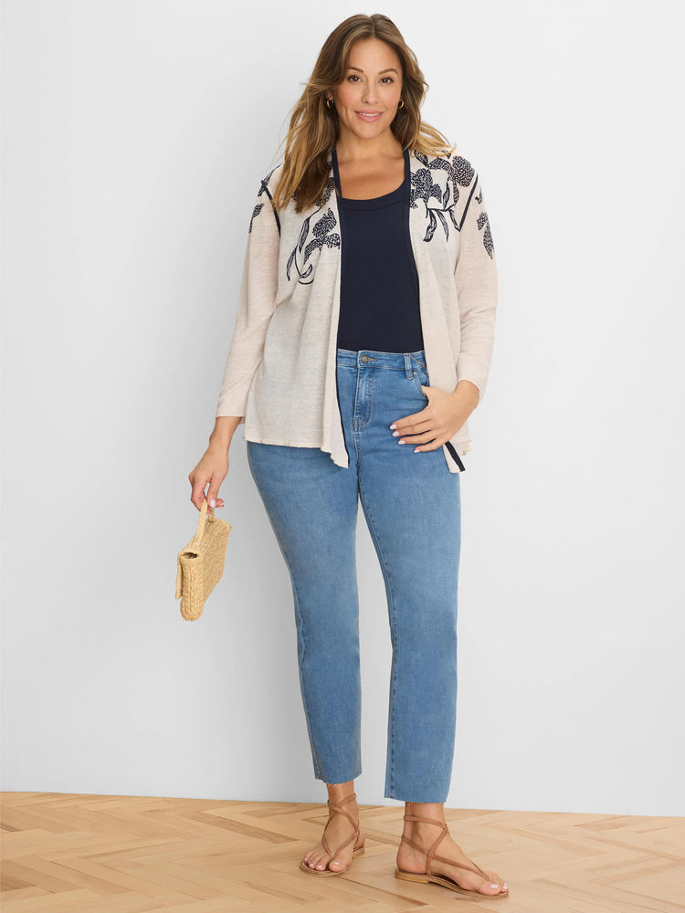 Light beige open cardigan with navy blue floral pattern on shoulders and front.