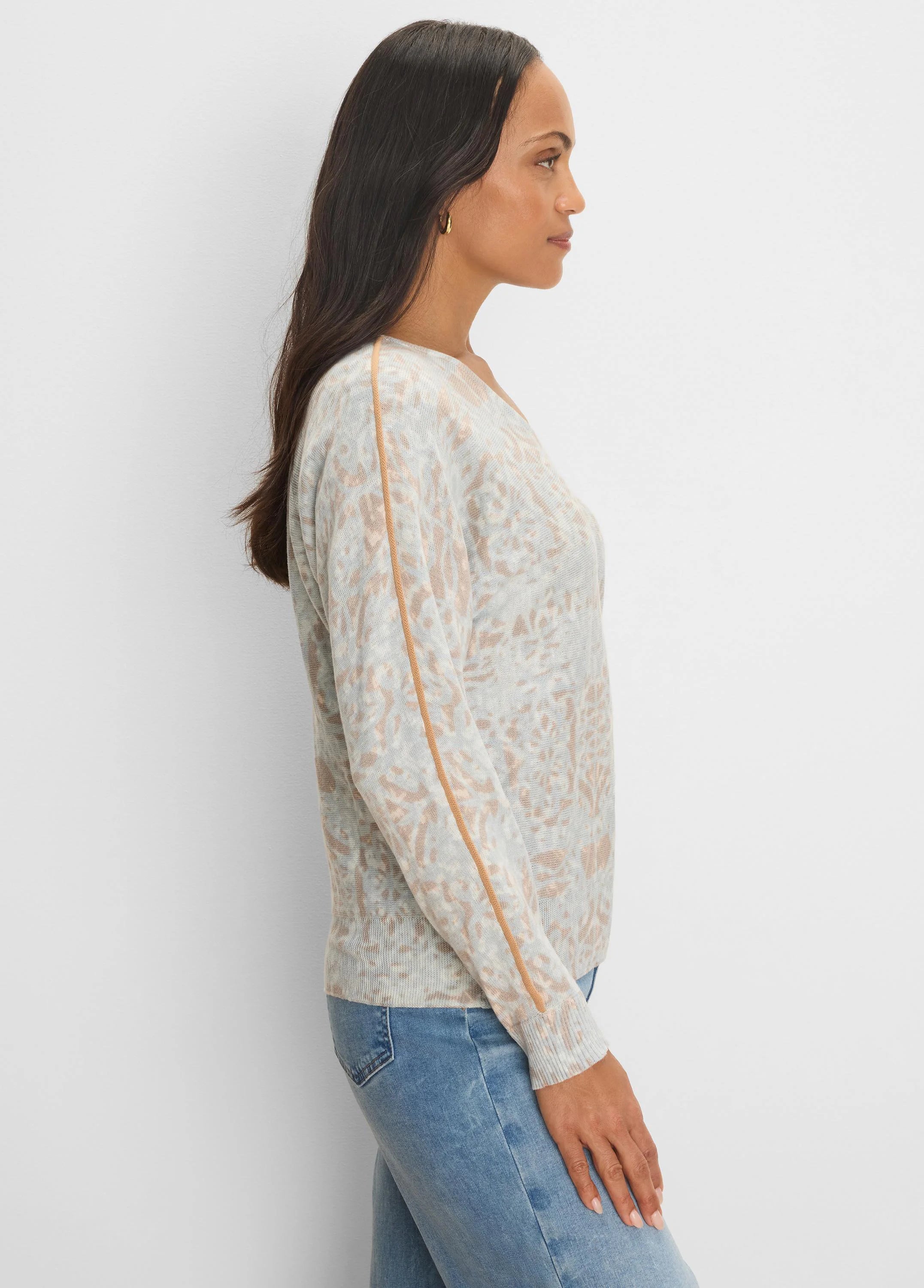 Gray v-neck sweater with mottled tan pattern and tan tipping stripes along outer sleeves.