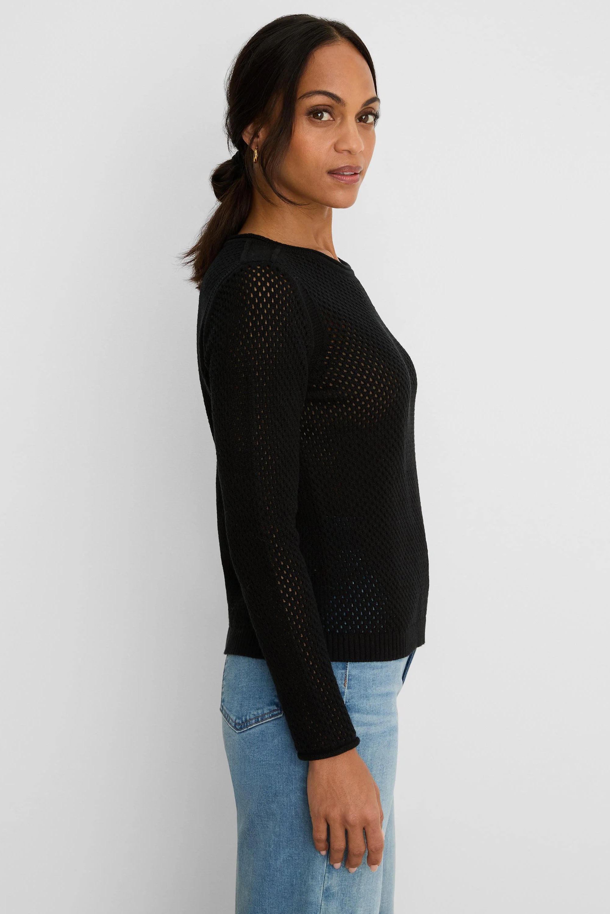 Black long-sleeve sweater with an open mesh knit, round neck, and ribbed cuffs/hem.