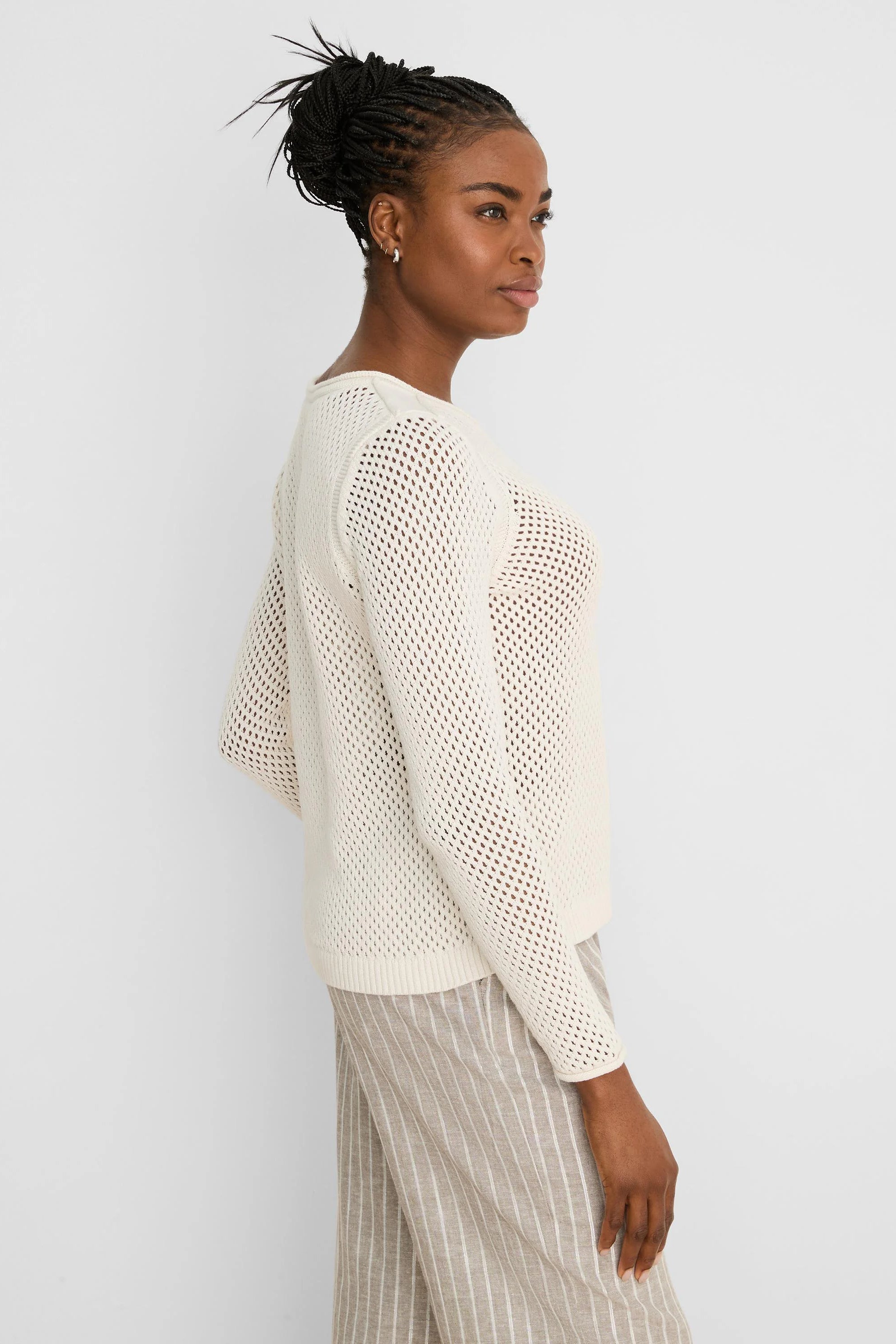 Cream mesh sweater with long sleeves and ribbed cuffs, hem, and neckline.