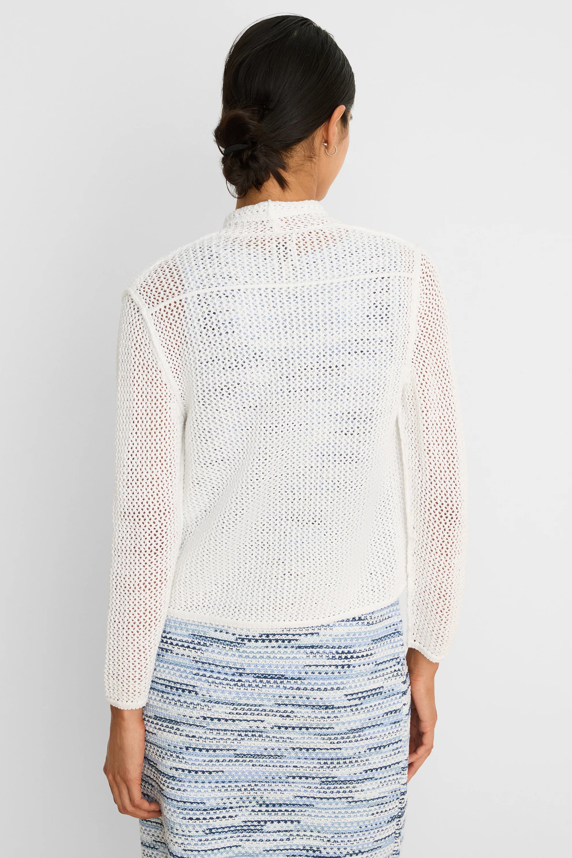 White mesh cocoon cardigan, back view. Loose, open knit with long sleeves.