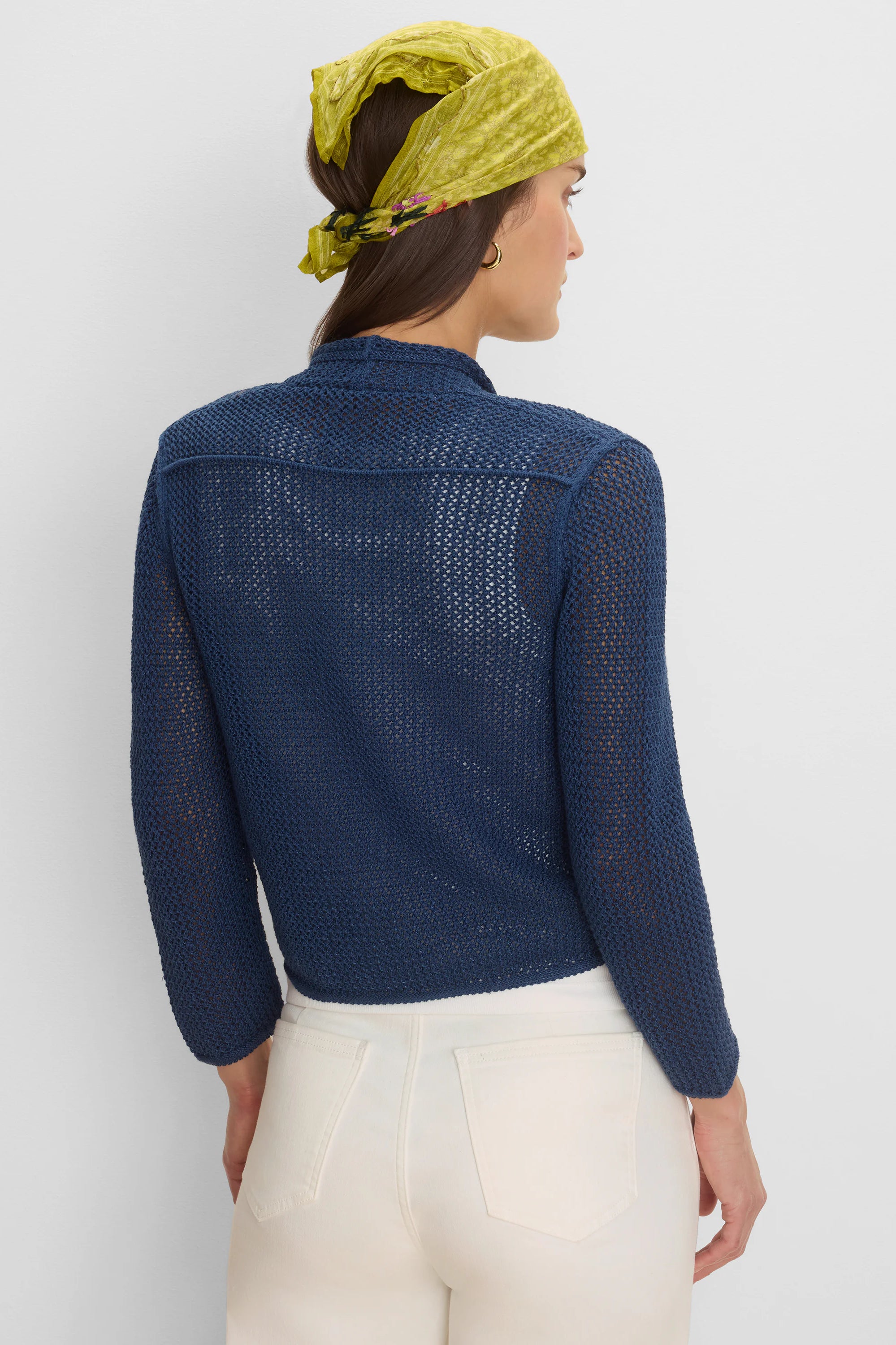 Navy blue mesh cardigan with open knit, revealing skin. Features a high collar & long sleeves. Back view.