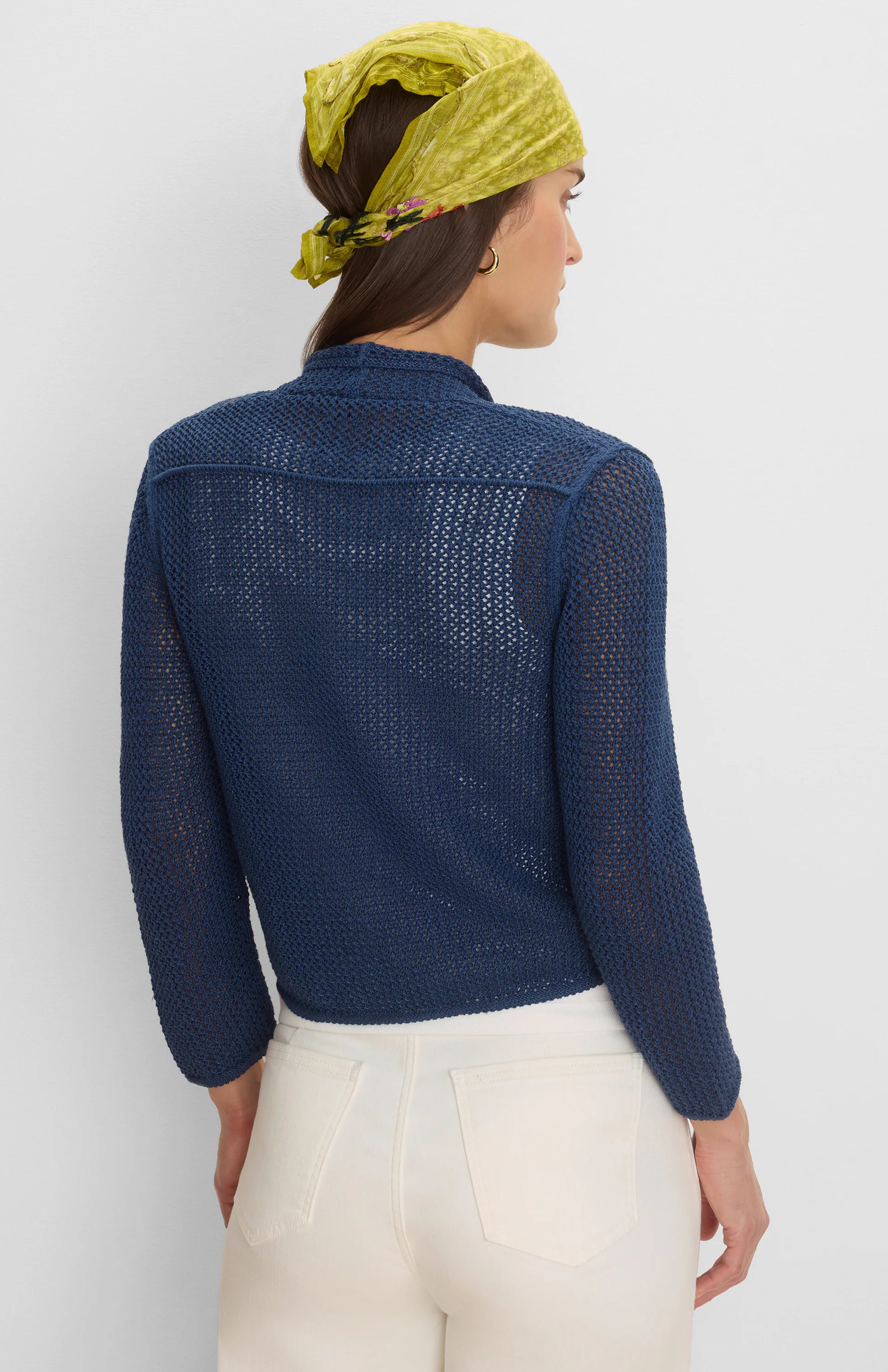 Navy blue mesh cardigan with open knit, revealing skin. Features a high collar & long sleeves. Back view.